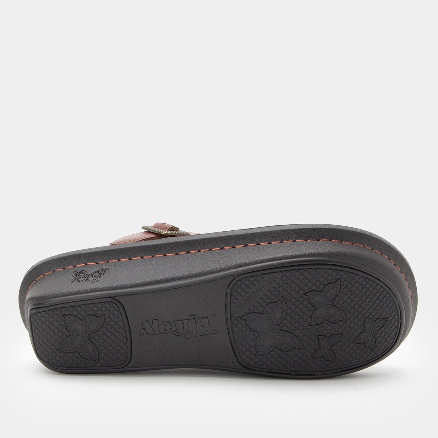 Brown clog with black sole on a white background