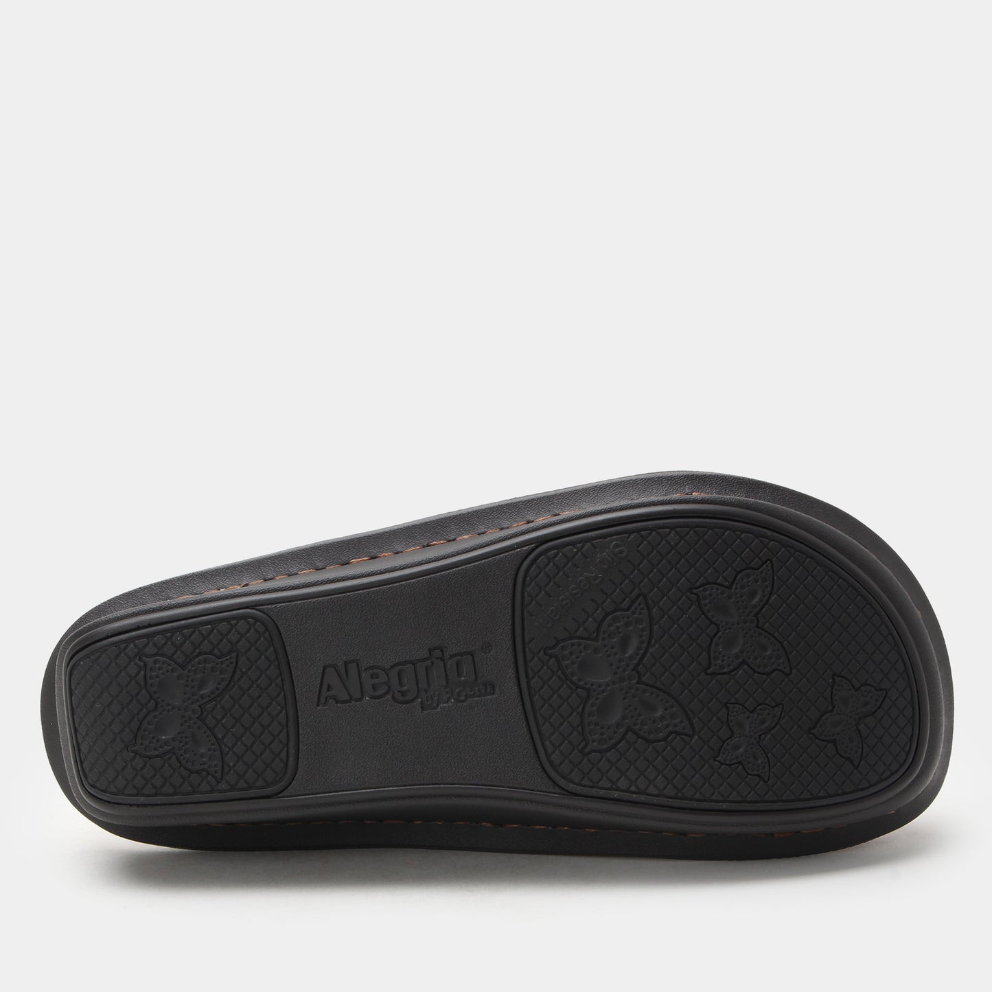 Black clogs sole with 'Alpina' branding on a light gray background