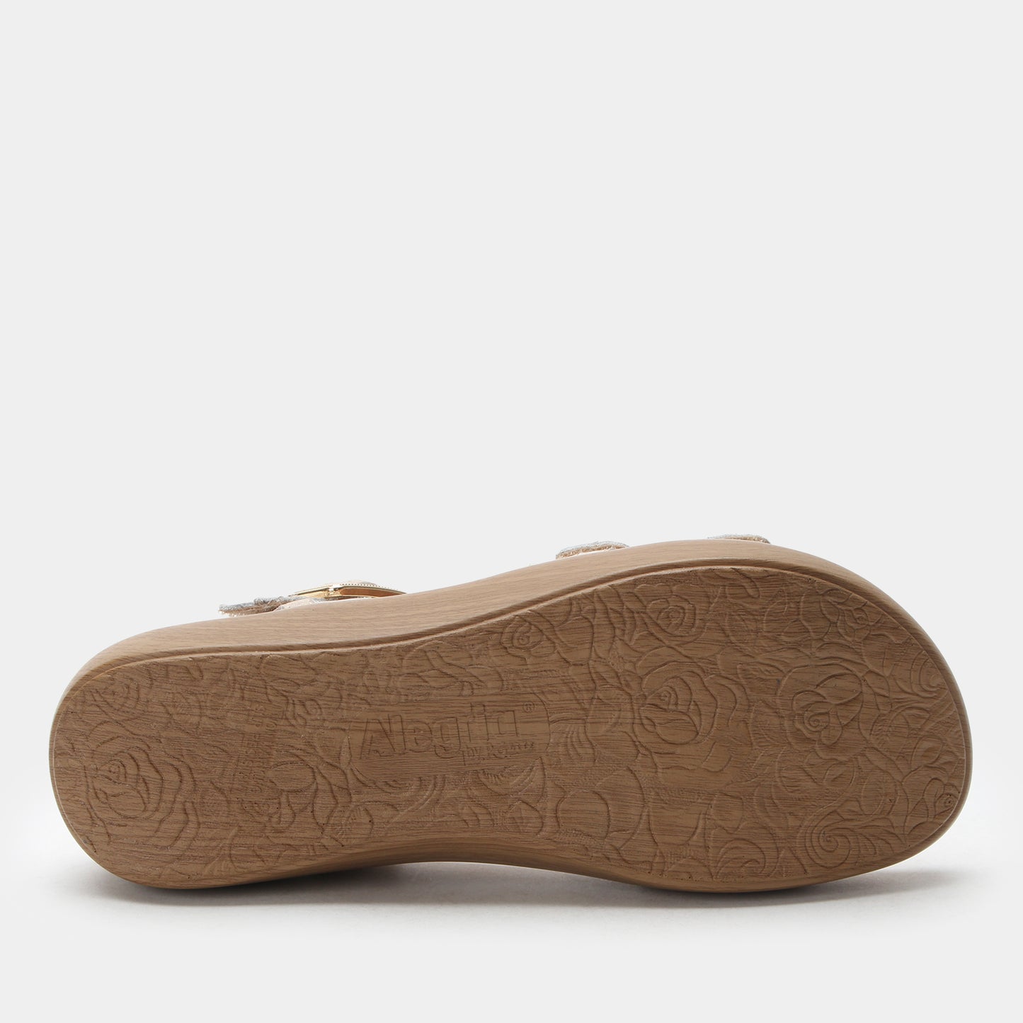 Tan sandal sole with embossed pattern on a white background