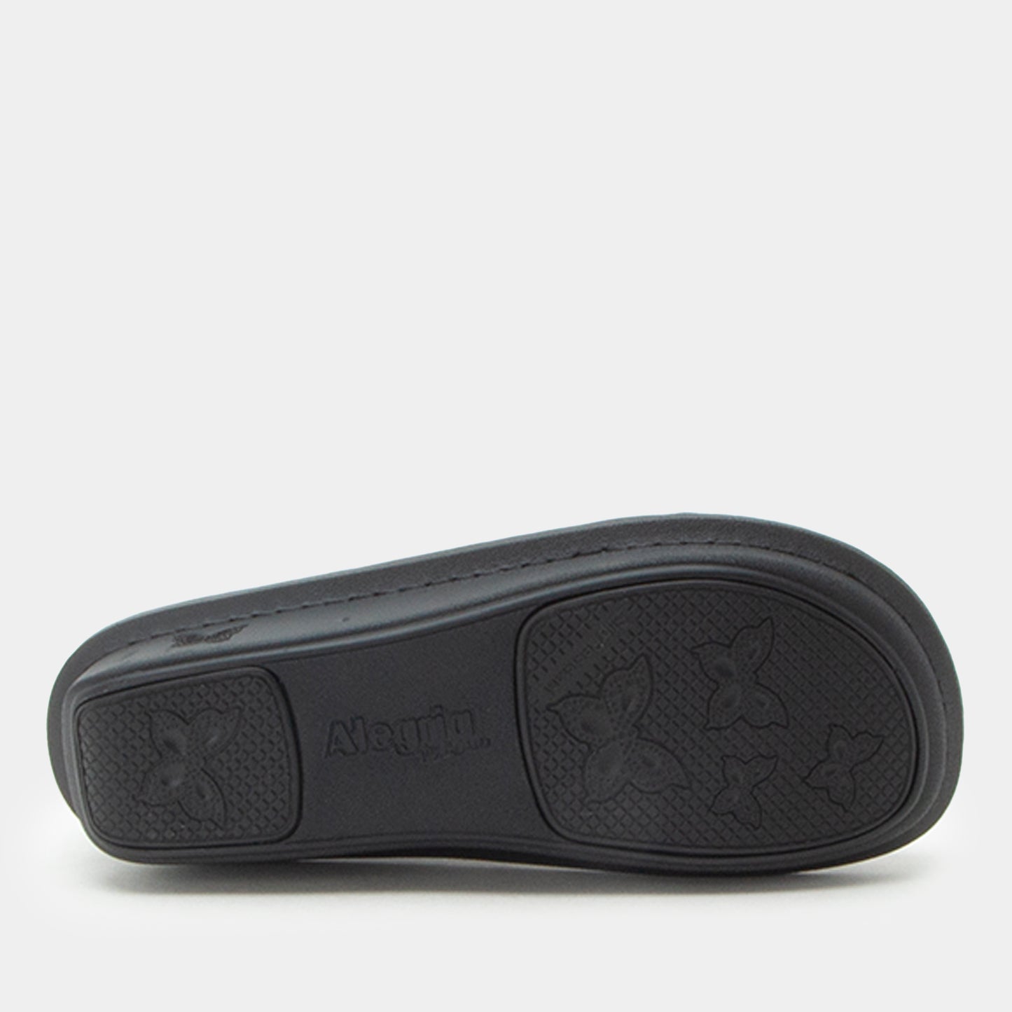 The black rubber outsole of a slide sandal, featuring embossed butterfly motifs and the brand name 'Aletin' in the center, shown against a light gray background.