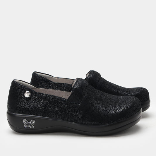 Black slip-on shoes with a butterfly logo on a white background