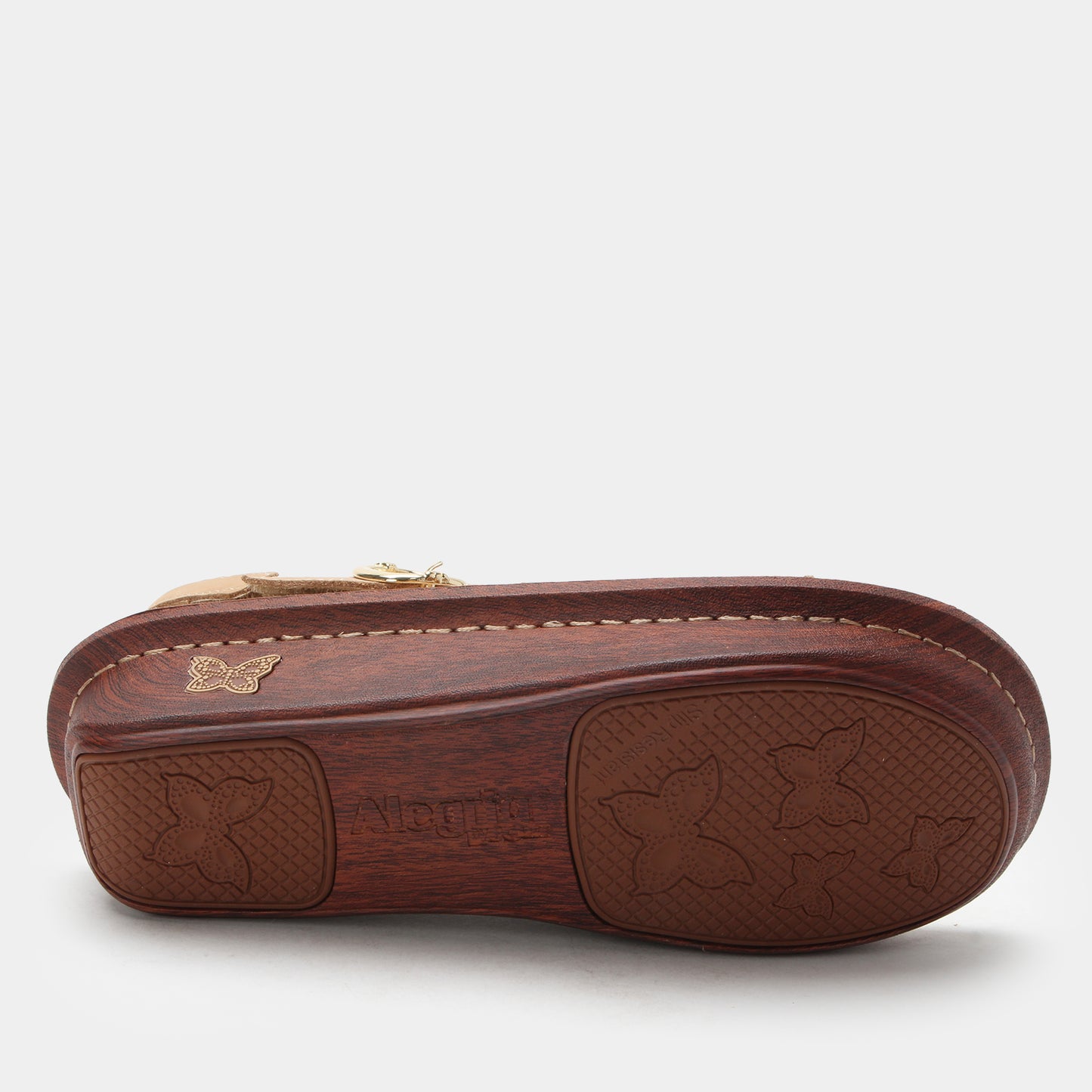 Brown leather shoe with embossed design on a white background