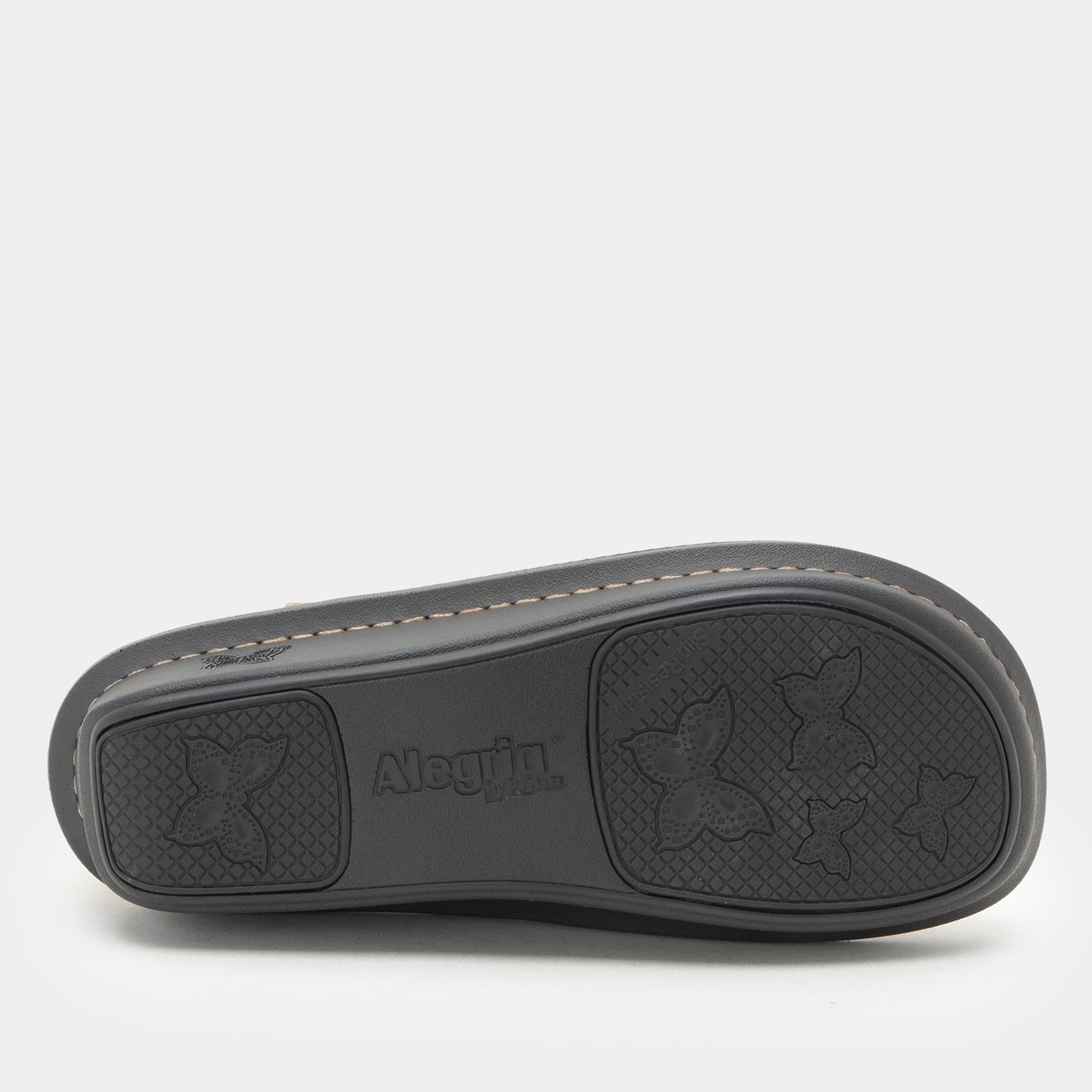 The black rubber outsole of a shoe, featuring embossed floral motifs and the brand name 'Albuilla' in the center, photographed against a light gray background.