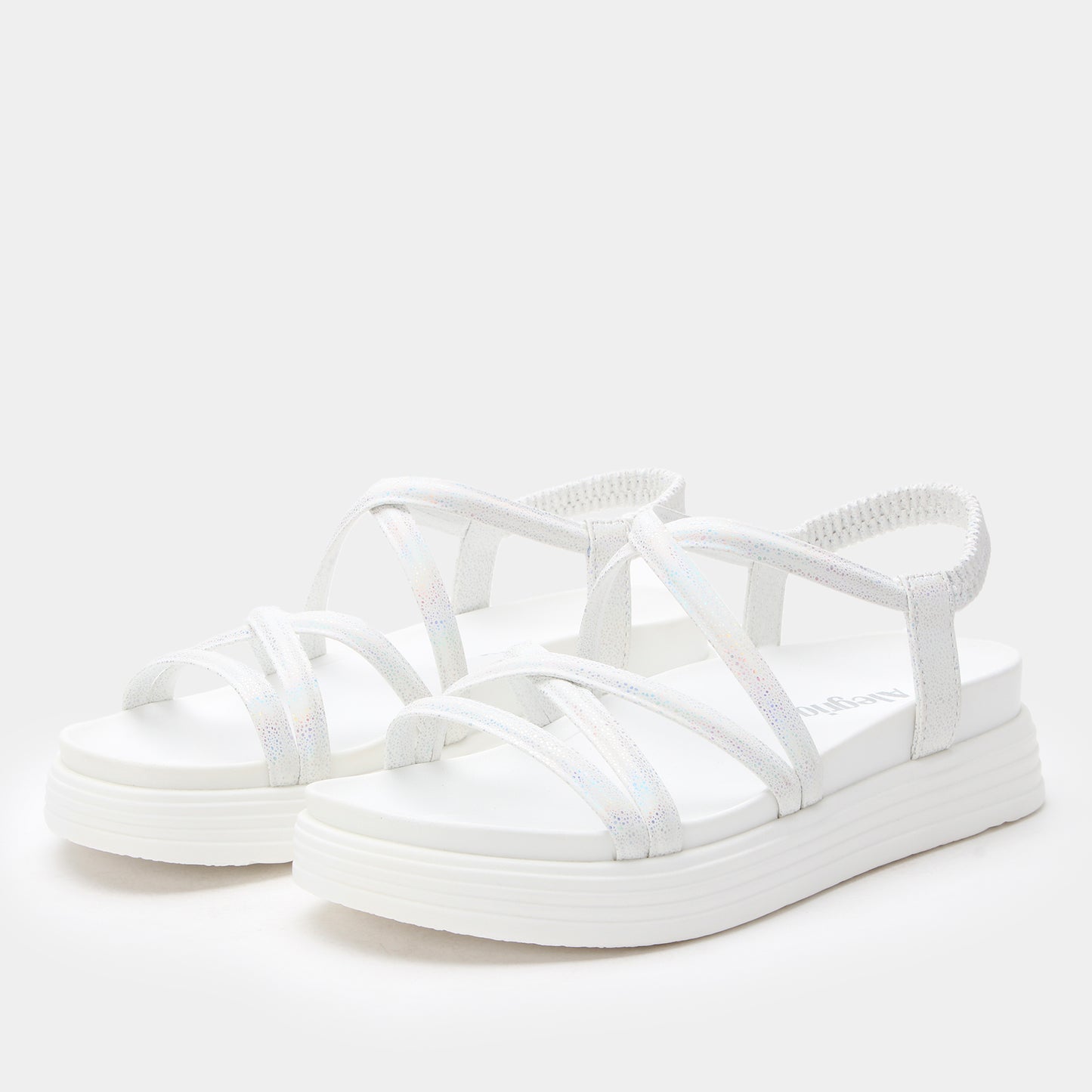 White sandals with strap design on a white background