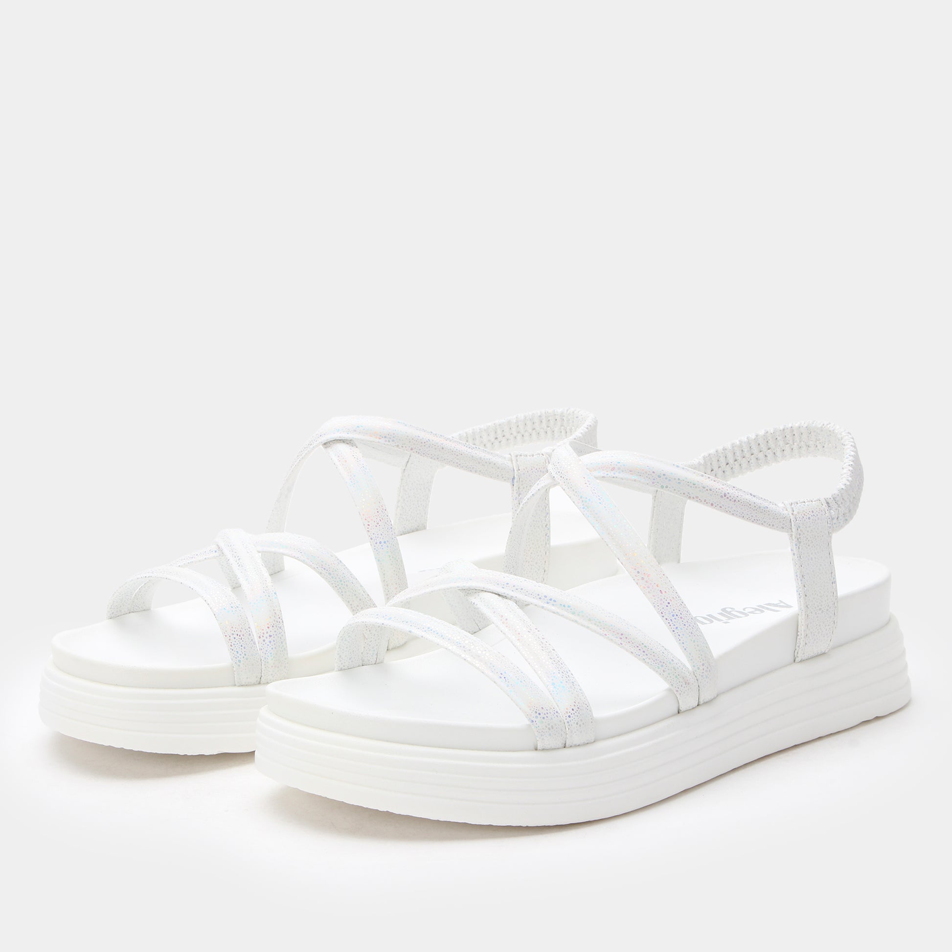 White sandals with strap design on a white background