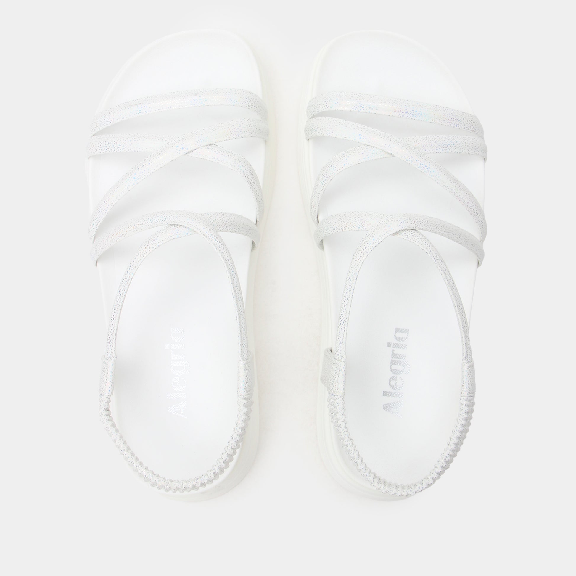 White baby booties with brand name on a light gray background