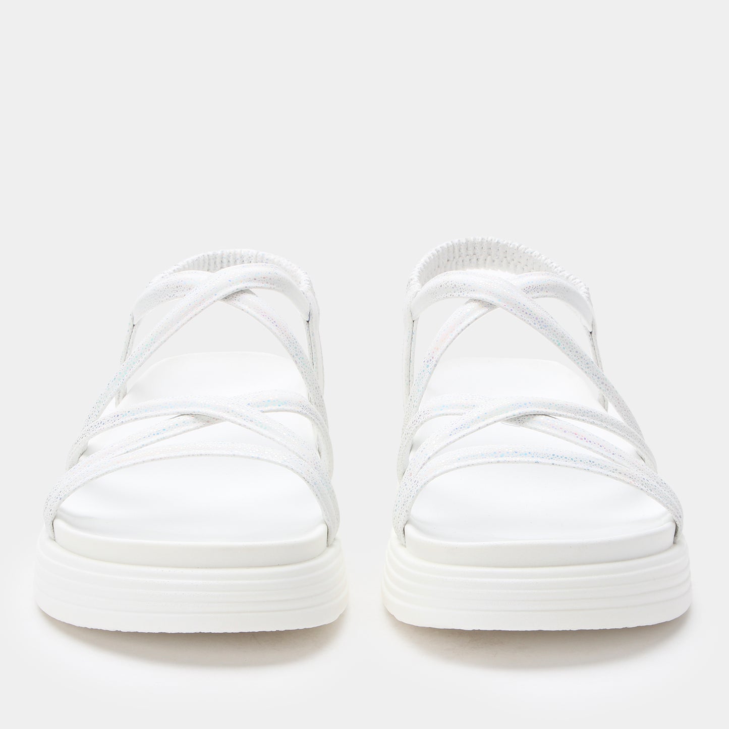 Pair of white slip-on sneakers on a light gray background