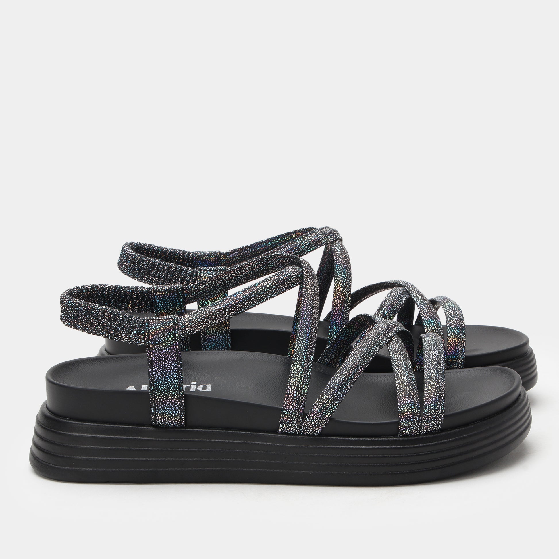 Black glittery sandals on a light gray background
