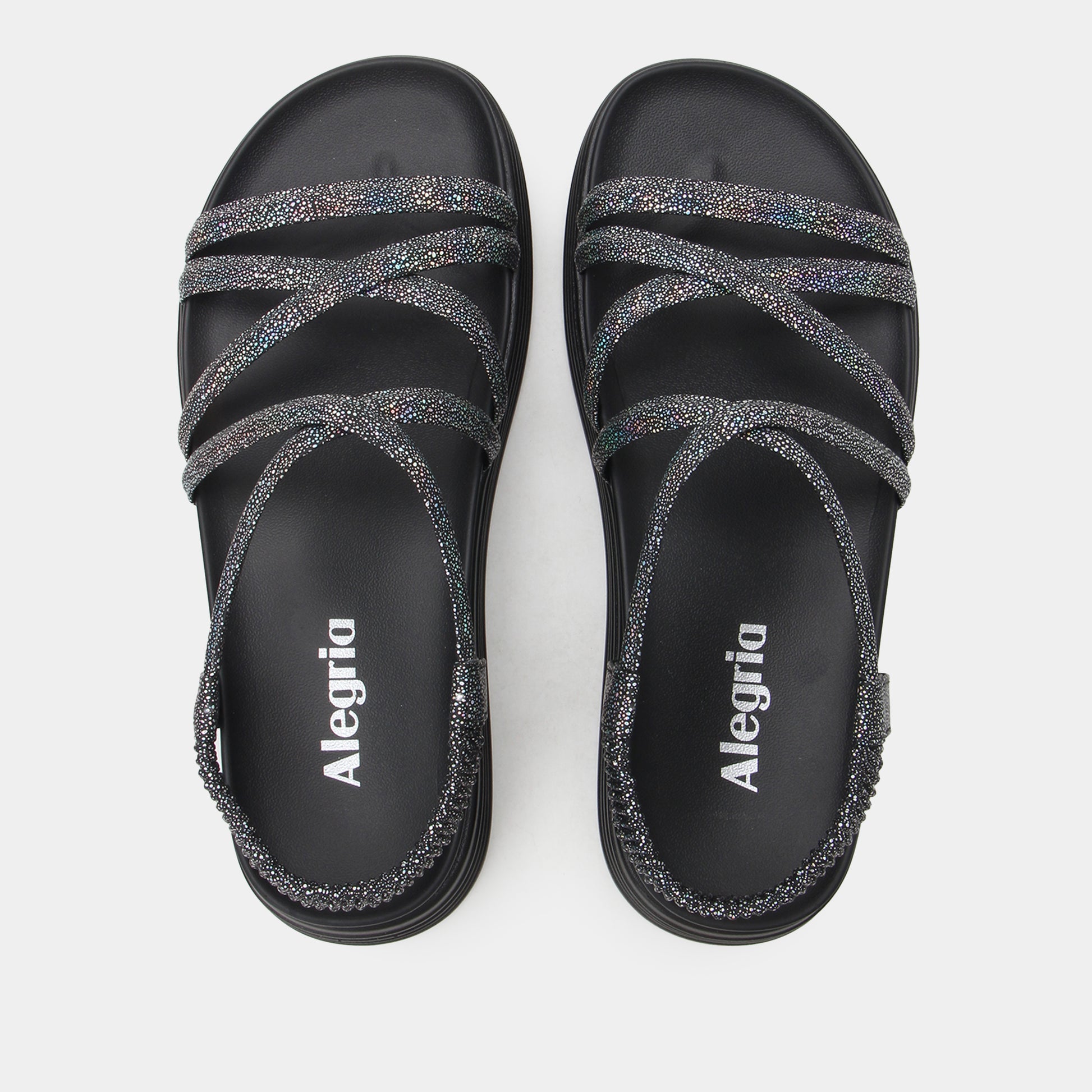 Black sandals with glittery straps and 'Alegria' branding on a white background