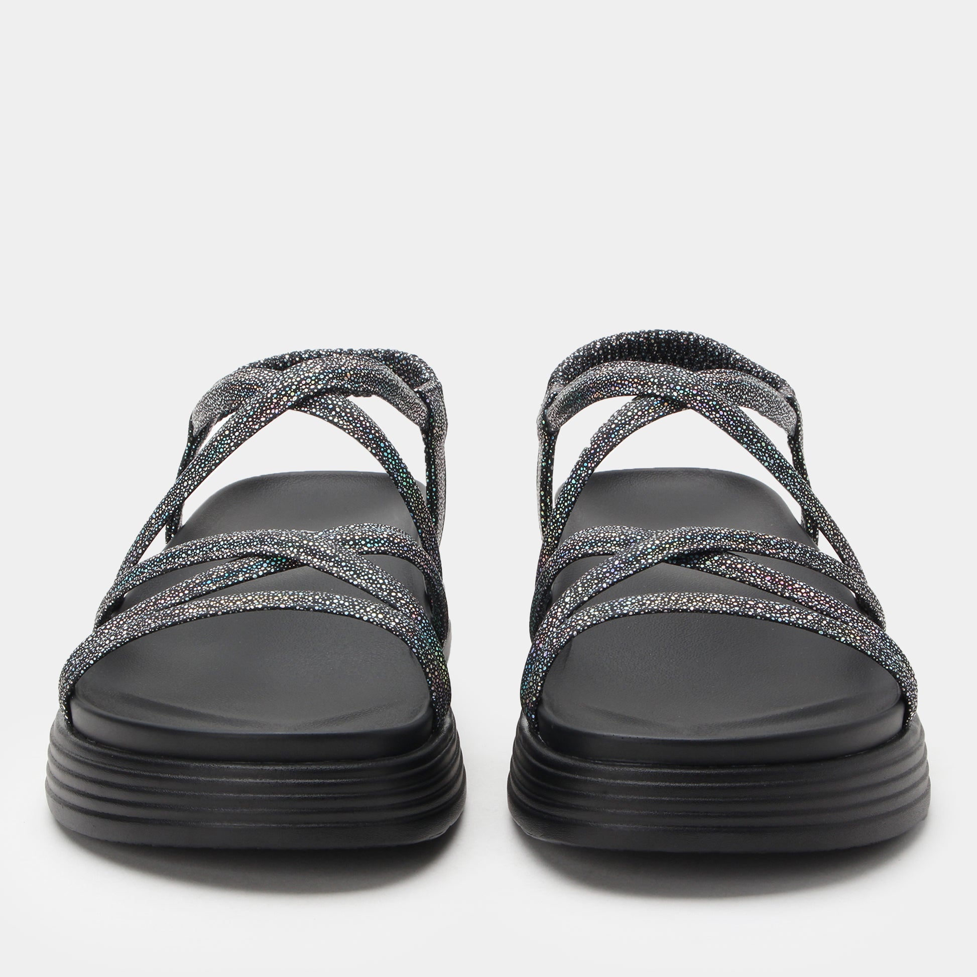 Pair of black sandals with glittery straps on a white background