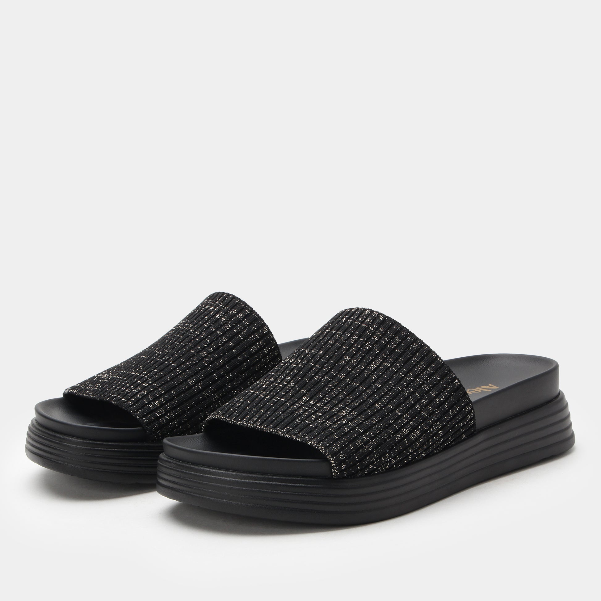 Black textured slide sandals on a light gray background