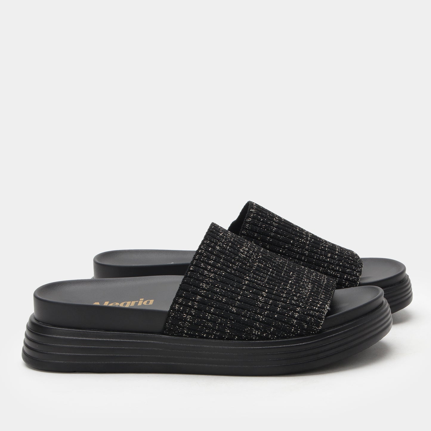 Black slide sandals with textured straps on a light gray background