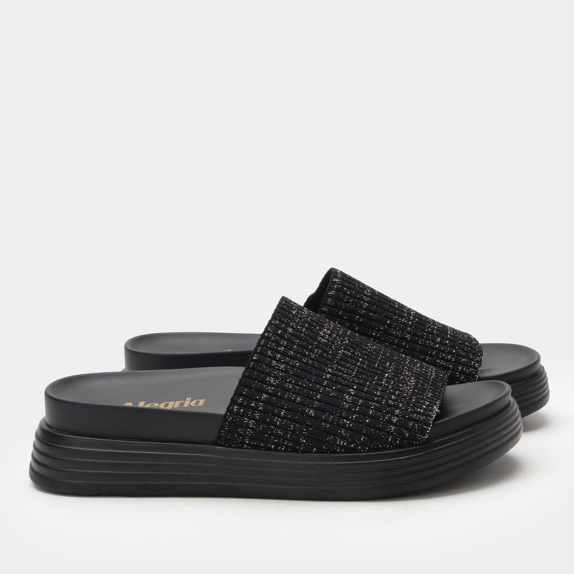 Black slide sandals with textured straps on a light gray background