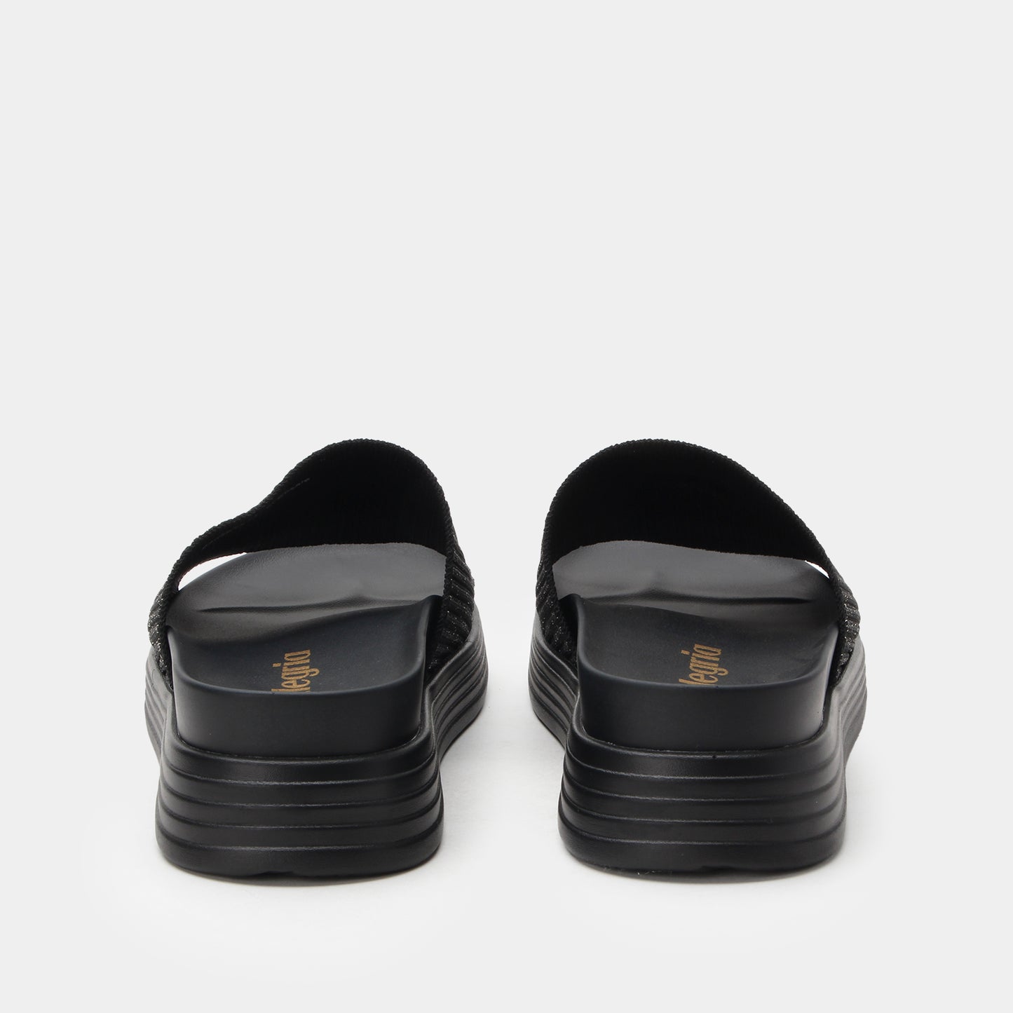 Black sandals with stacked sole design on a white background