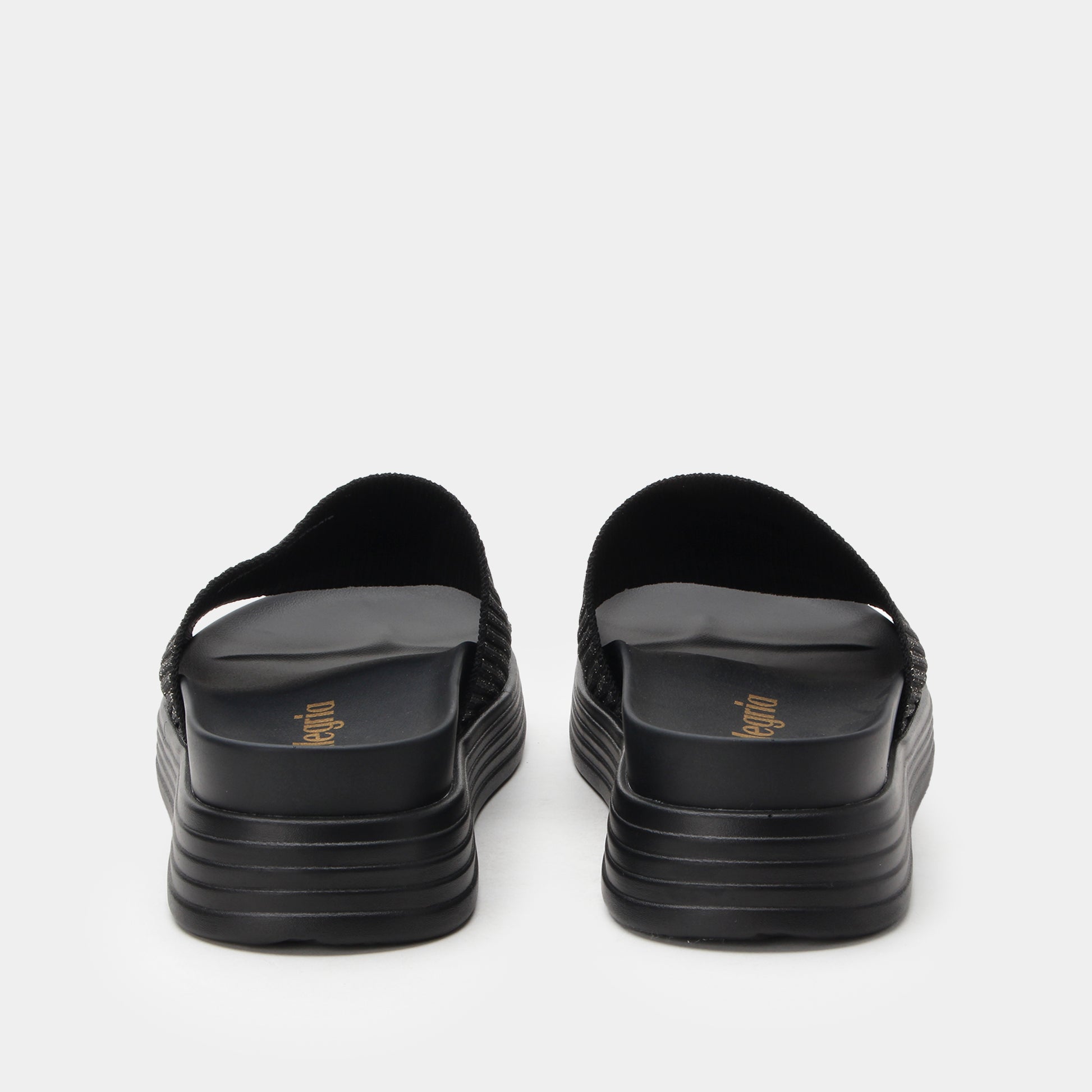 Black sandals with stacked sole design on a white background
