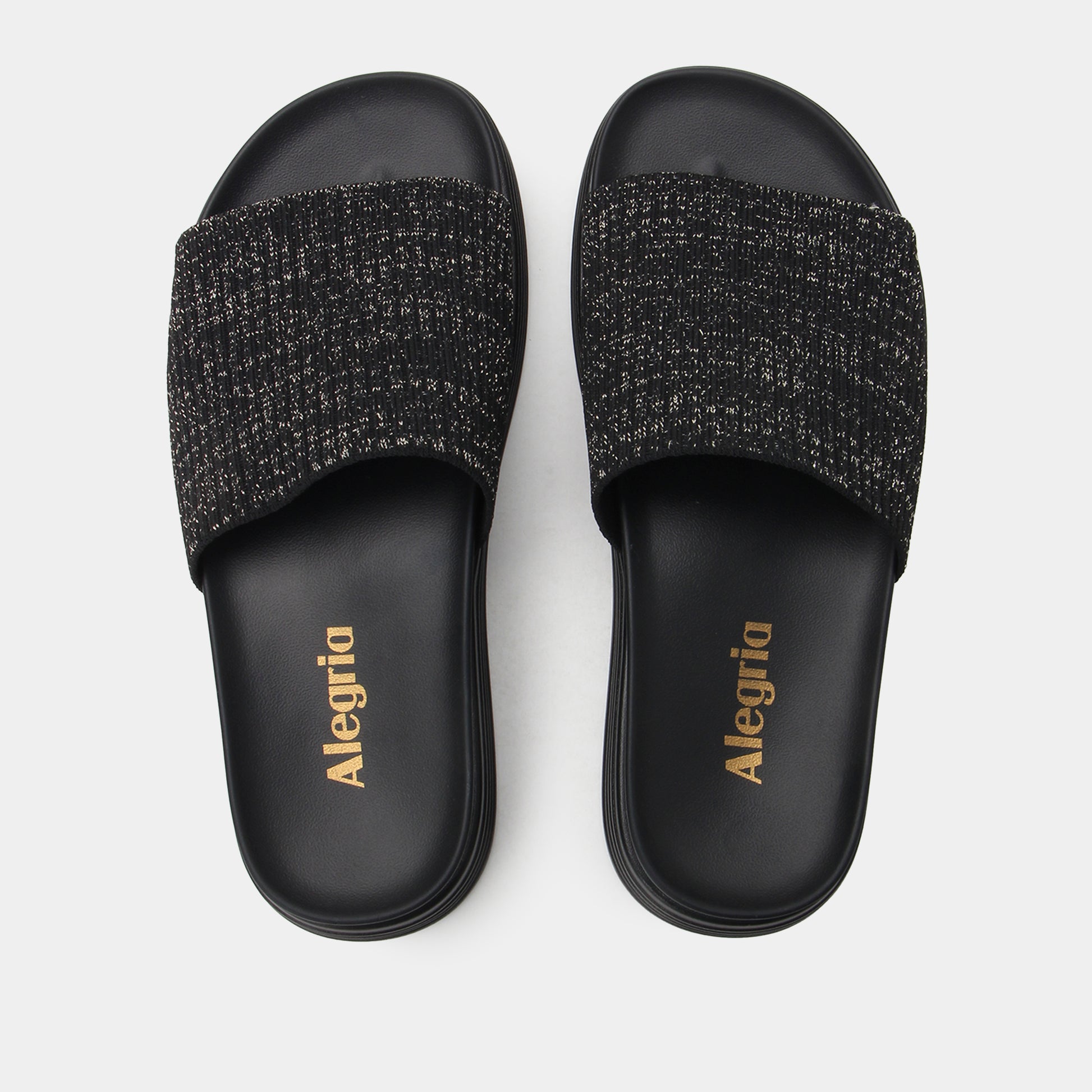 Black slide sandals with textured strap and 'Alegria' branding on a white background