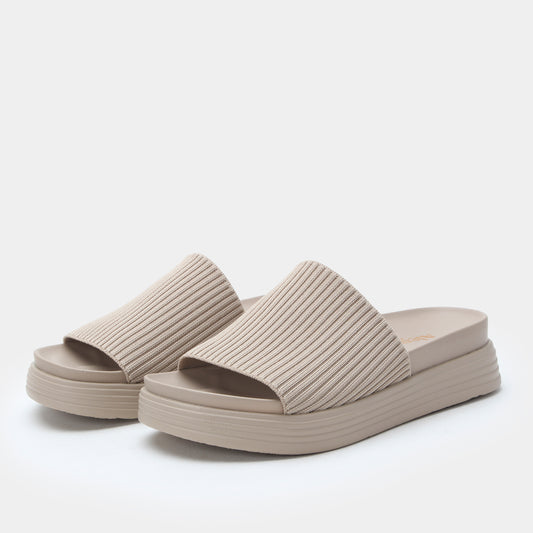 Beige ribbed sandals on a white background
