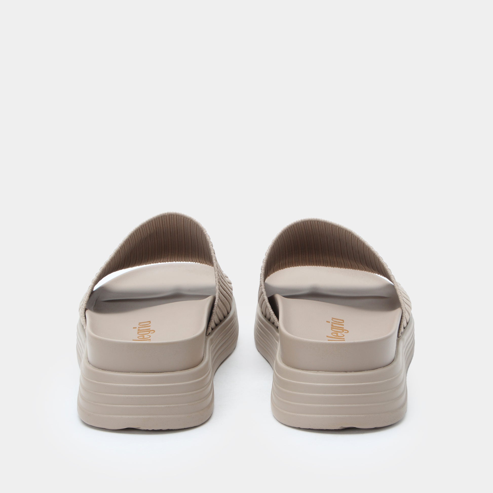 Pair of beige sandals on a white background