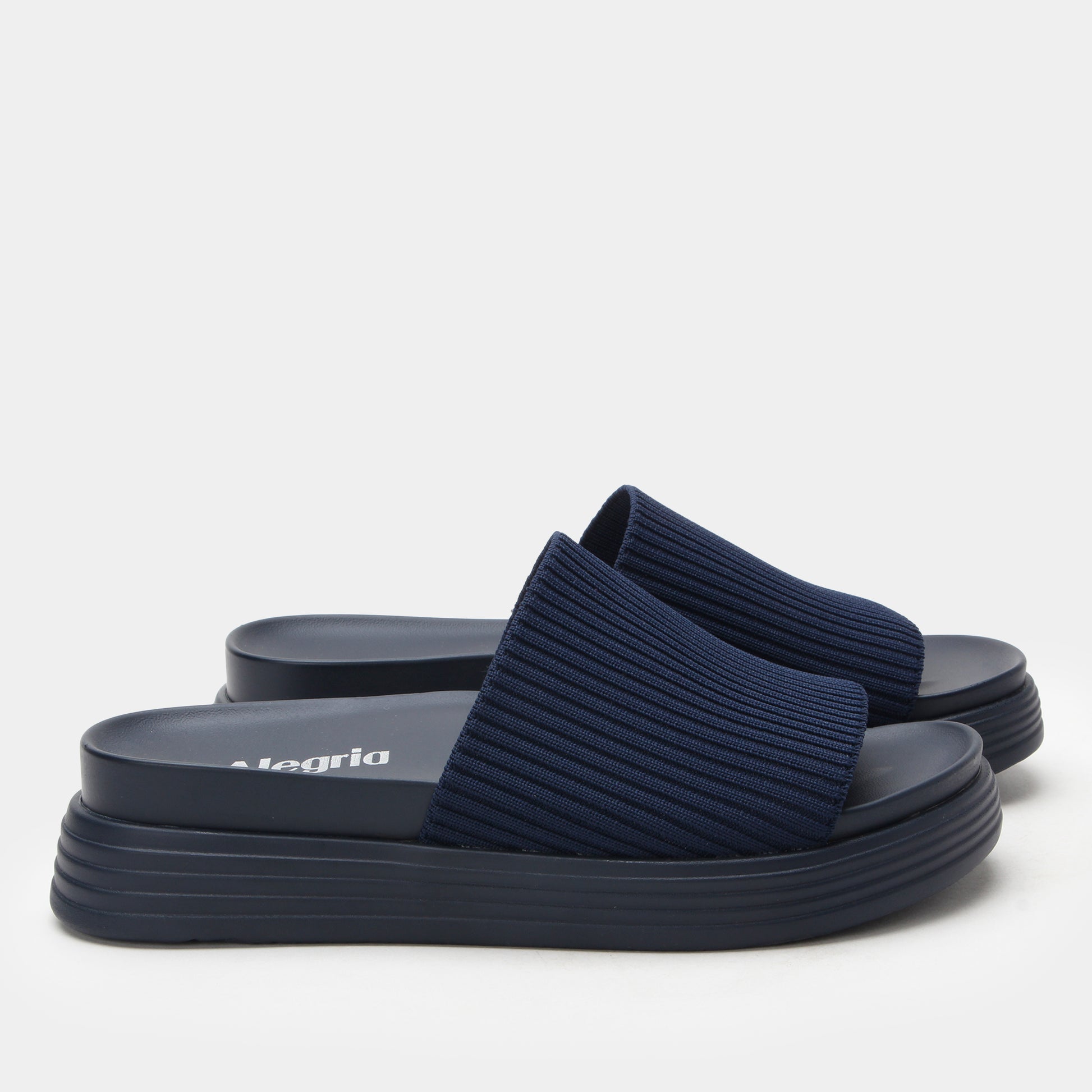 Navy blue sandals with a ribbed texture on a white background