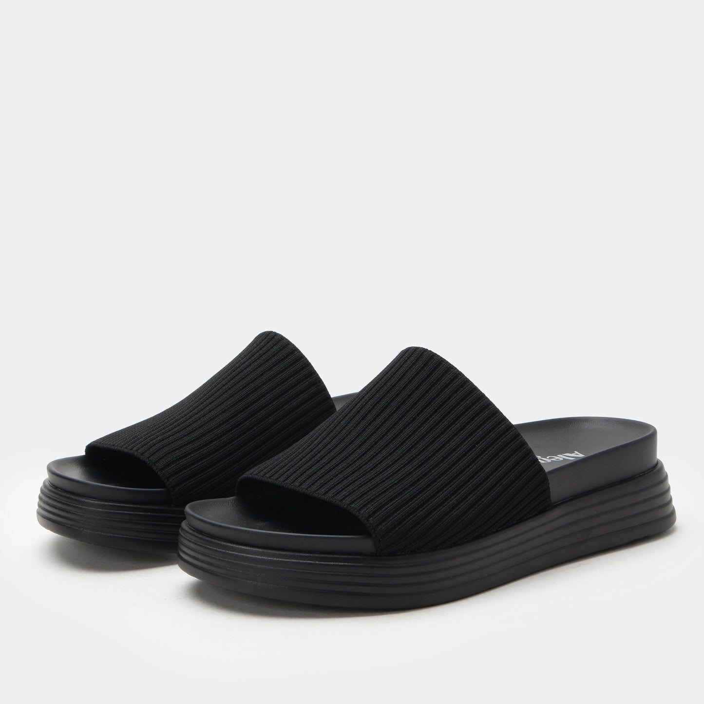 Black platform sandals on a white background