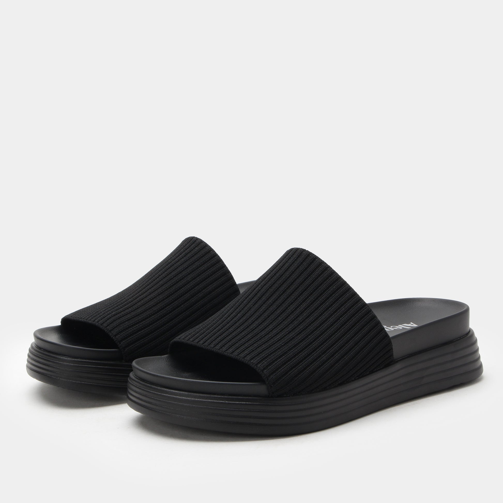 Black platform sandals on a white background