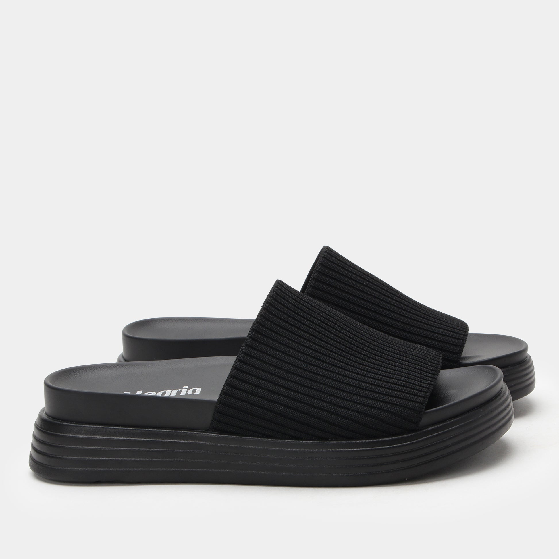 Black platform sandals on a white background