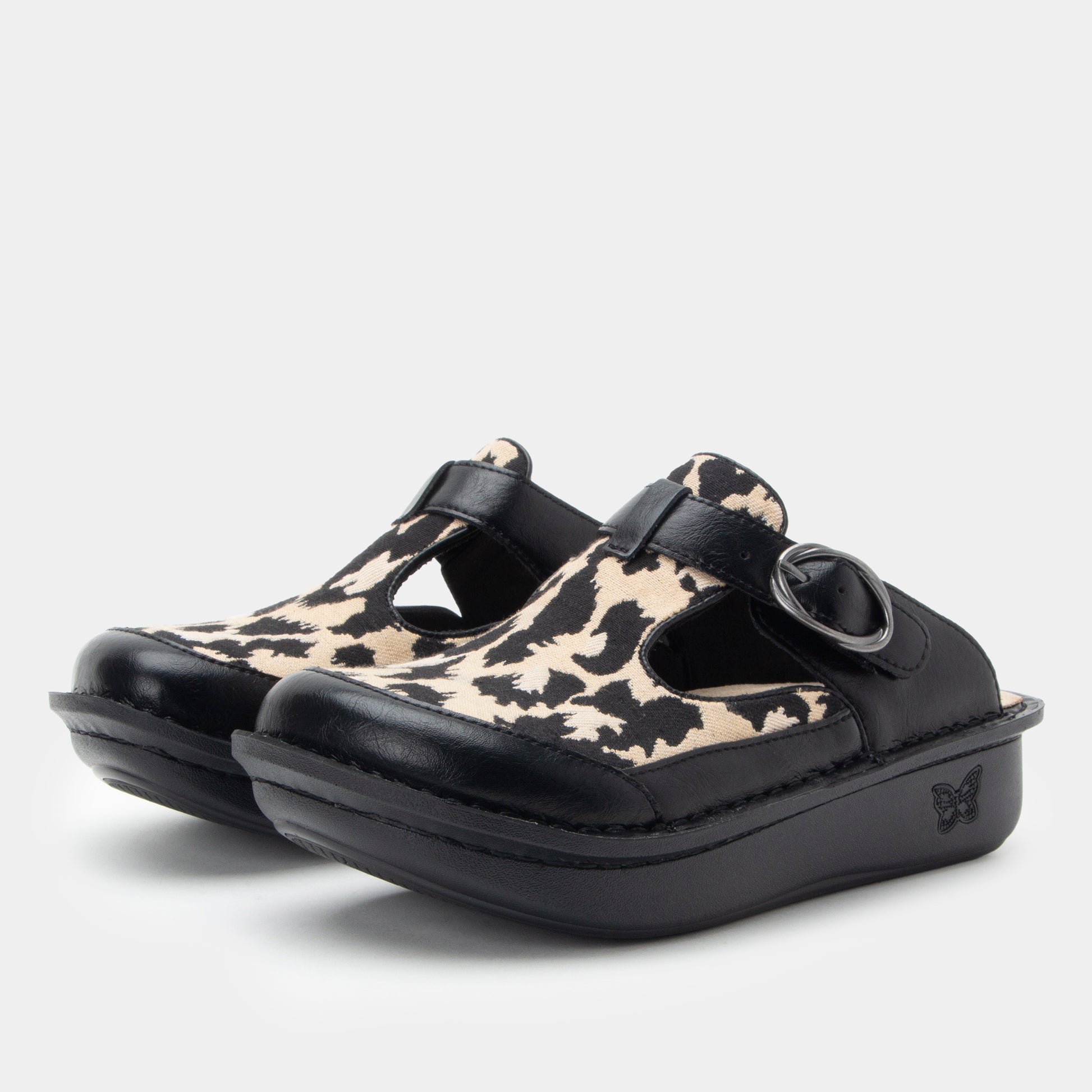 Pair of clogs with black and beige pattern on a white background