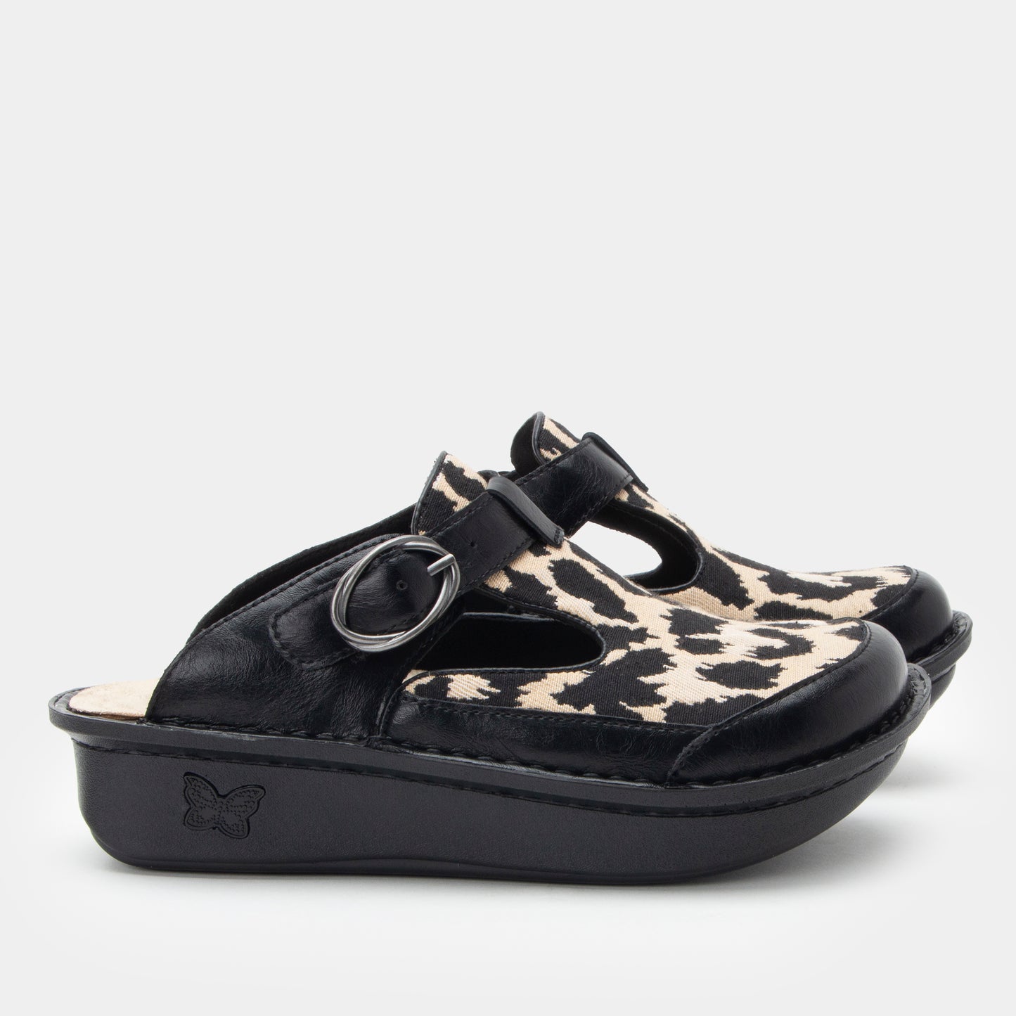 Black clog with leopard print insole on a light gray background