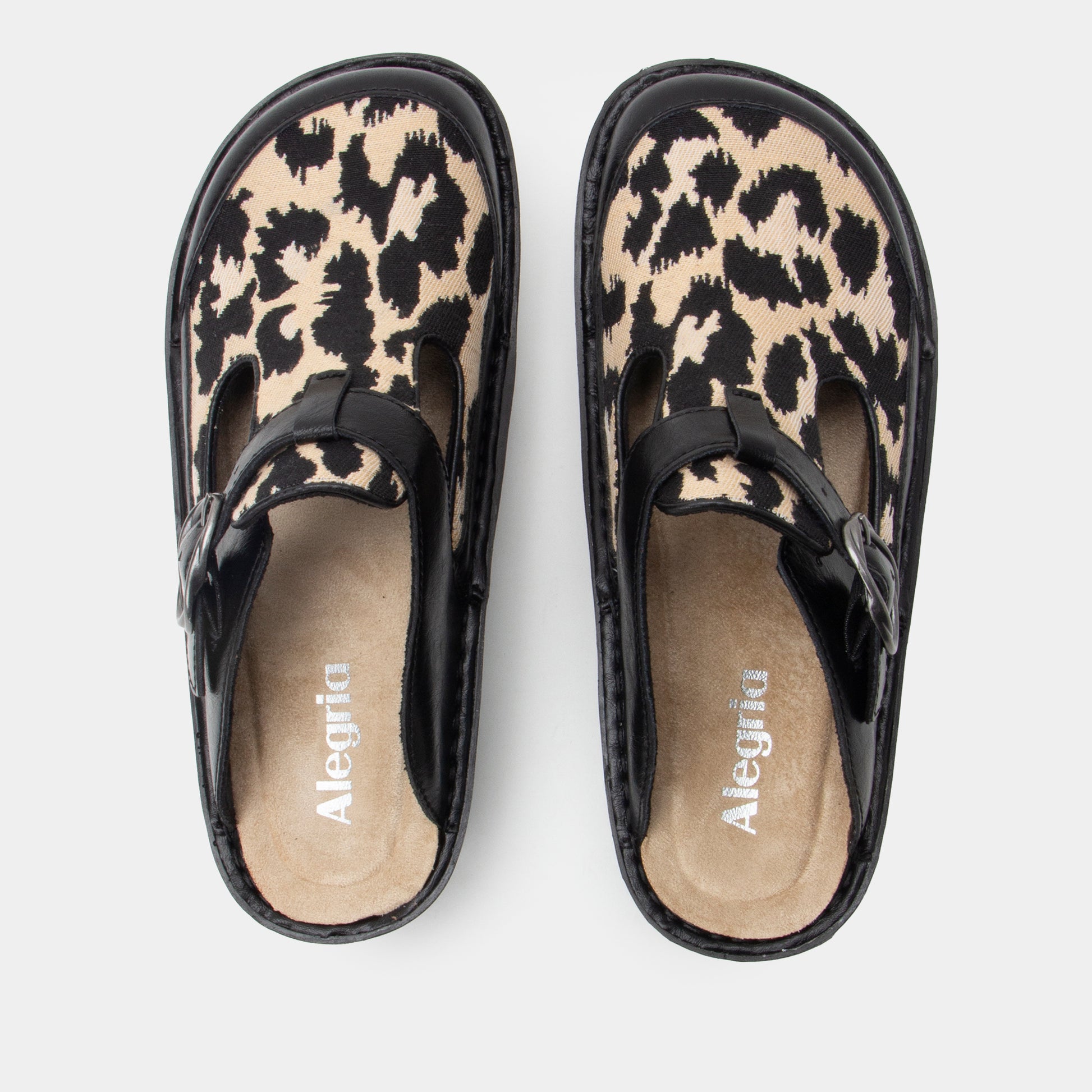 Pair of leopard print clogs with black straps on a white background