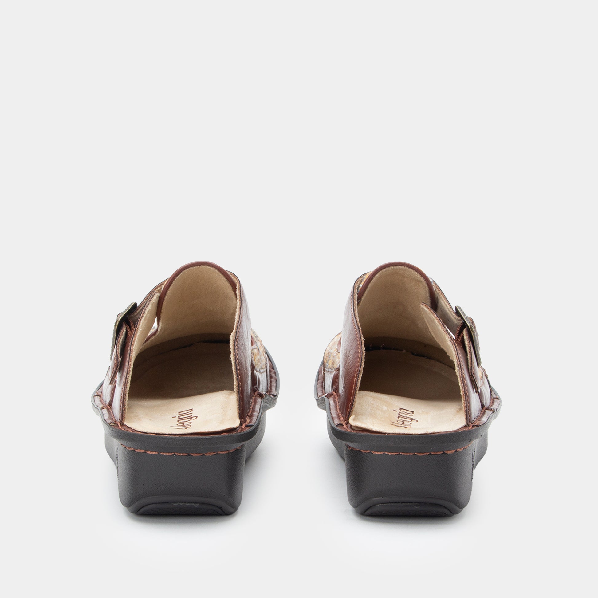 Pair of brown open-toe shoes on a white background