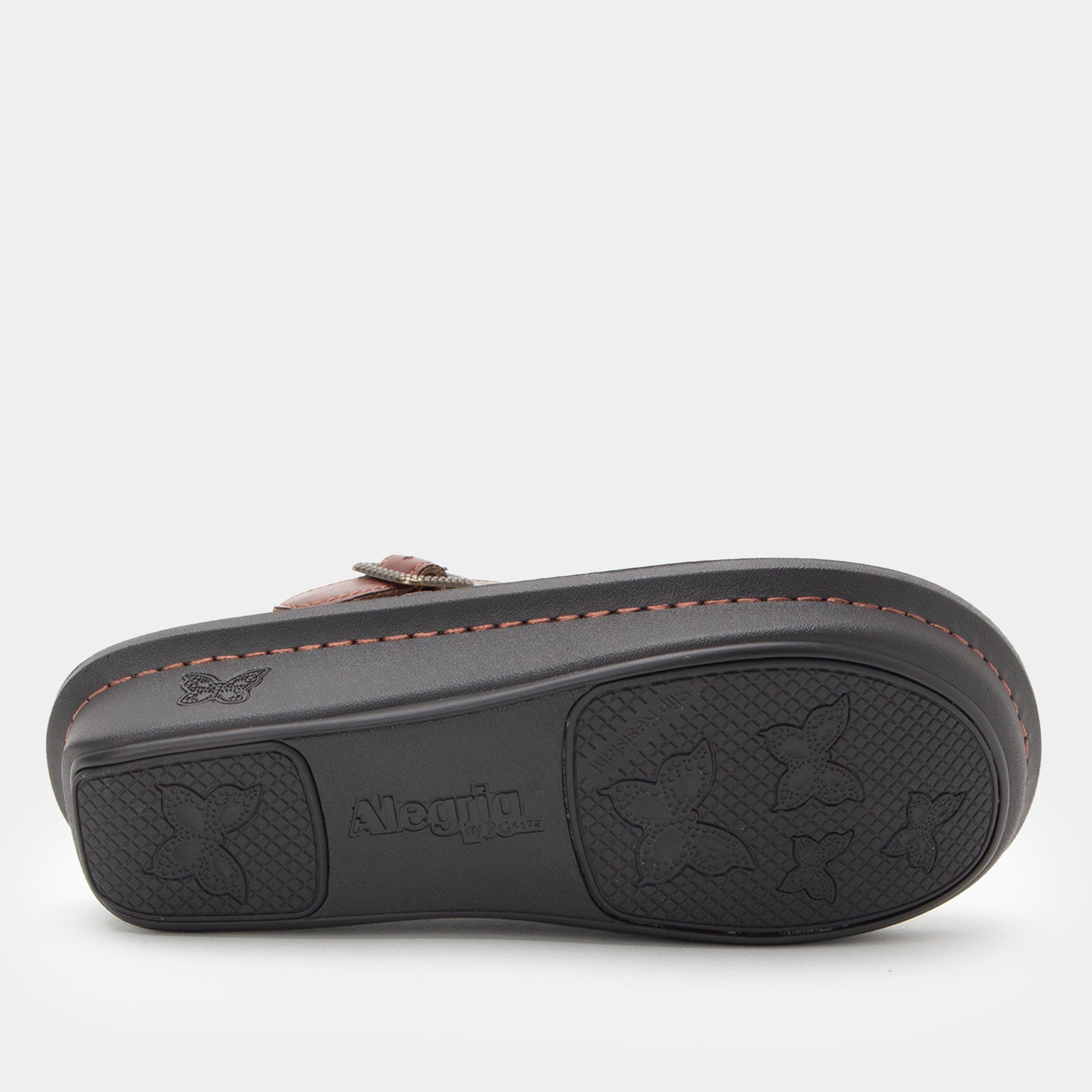 Brown clog with black sole on a white background