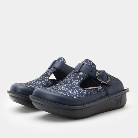 Pair of navy clogs with floral pattern on a white background