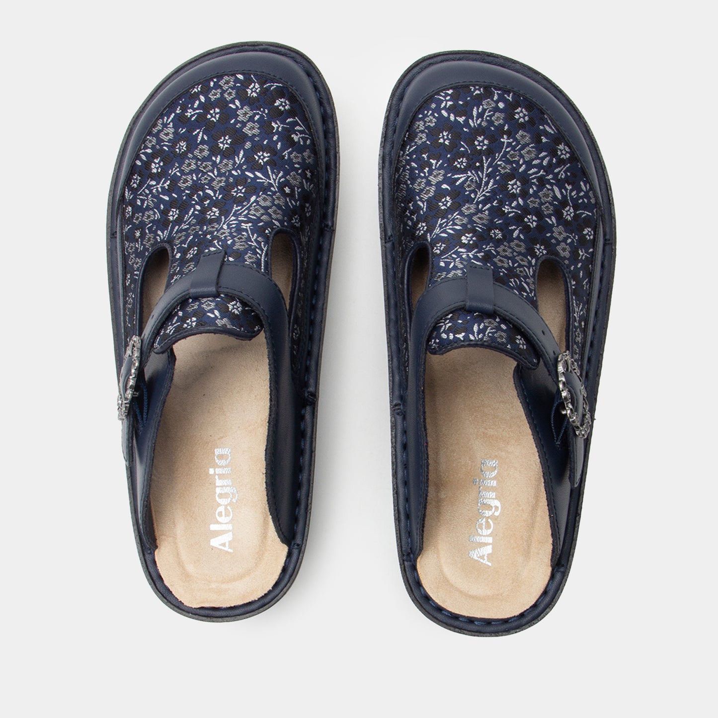 Pair of navy floral-patterned clogss on a white background
