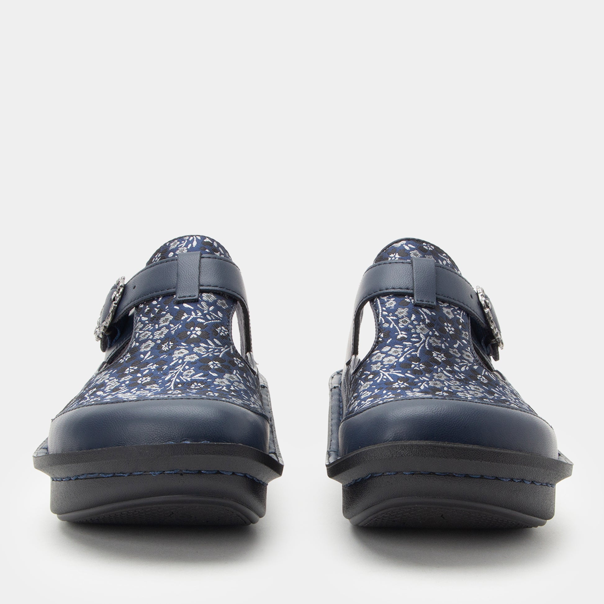 Pair of navy floral-patterned shoes on a white background