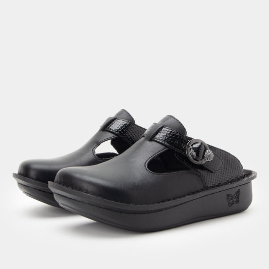 Pair of black clogs with a buckle on a light gray background