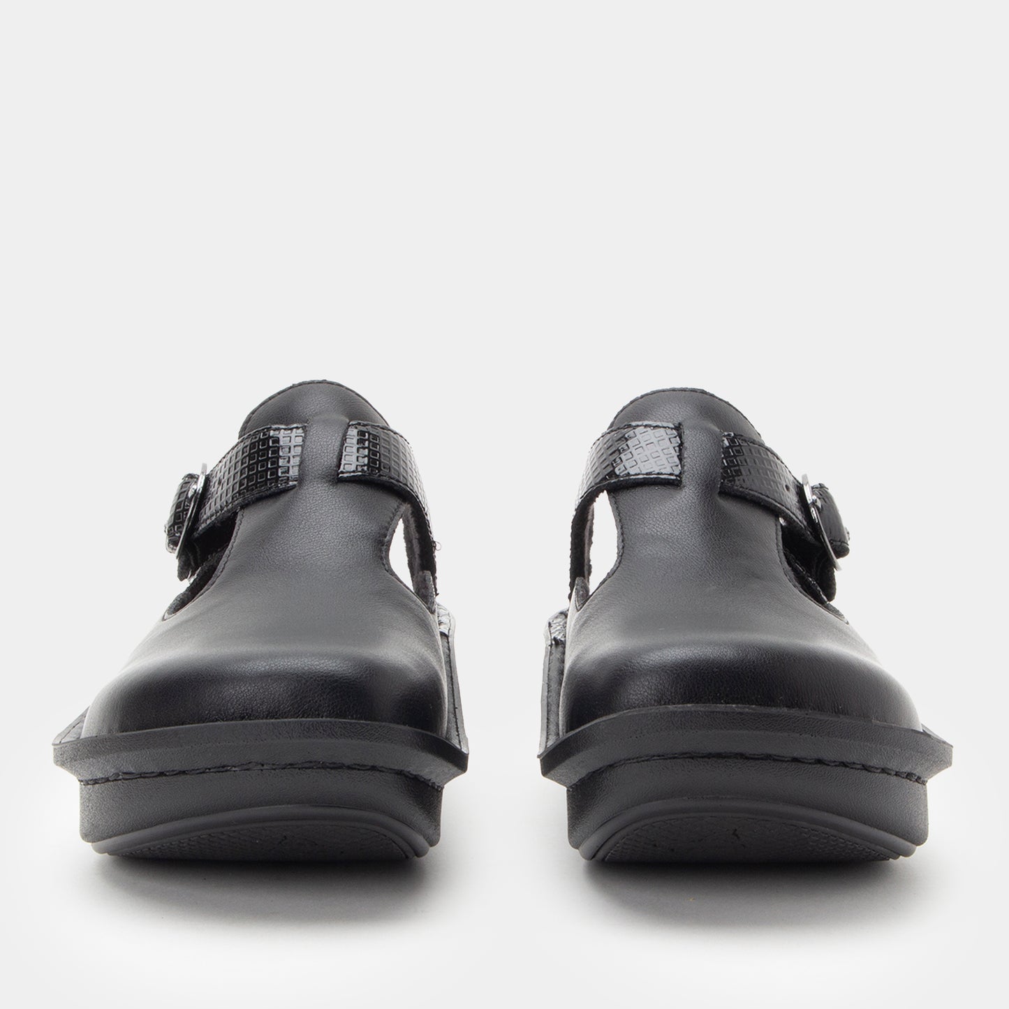 Pair of black clogs on a white background