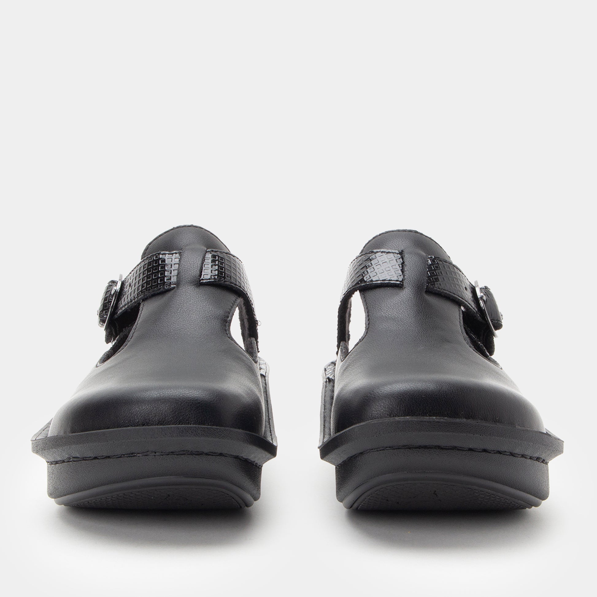 Pair of black clogs on a white background