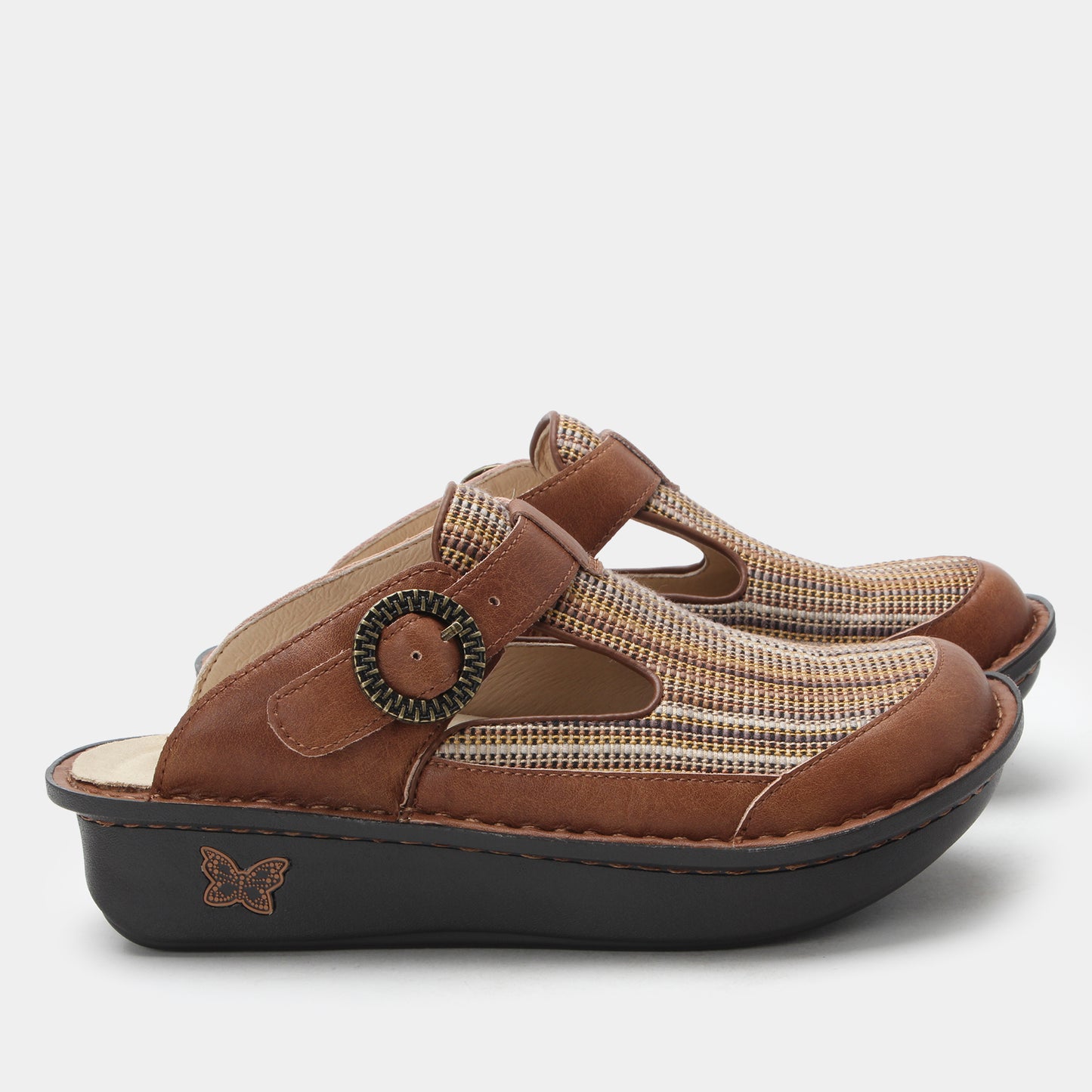 Pair of brown clogs with a decorative buckle on a white background