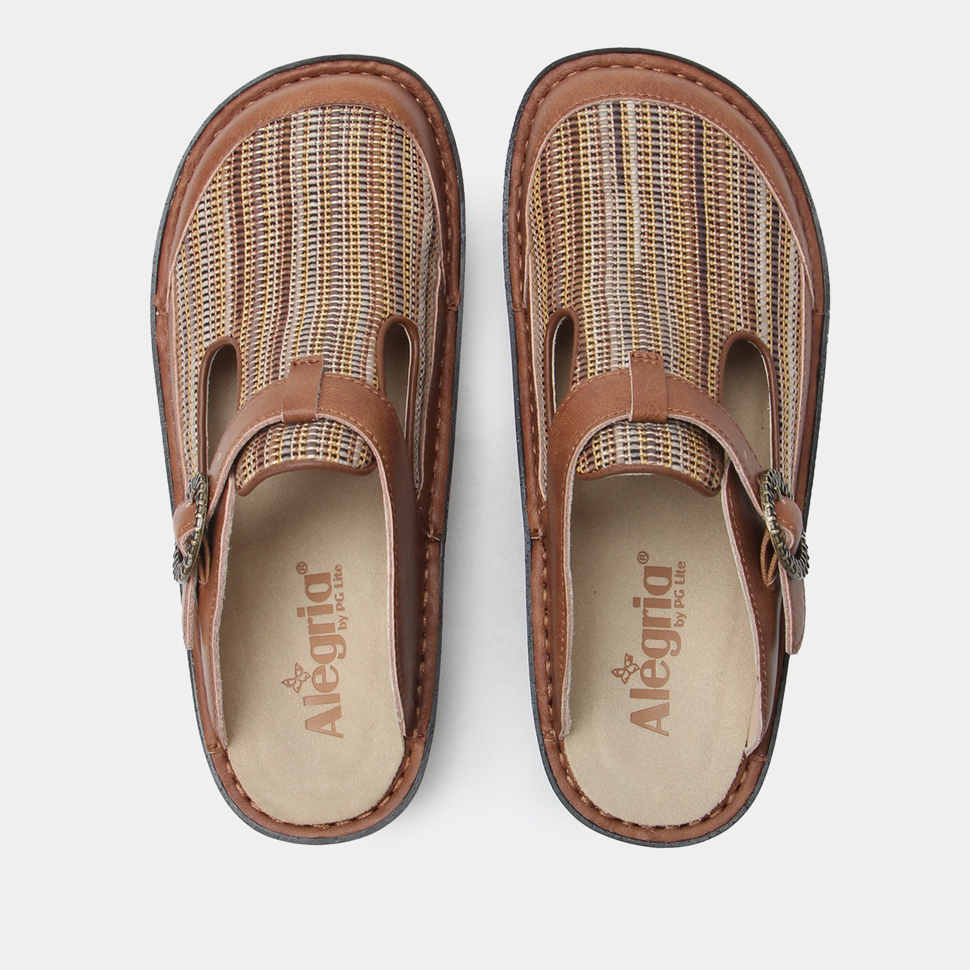 Pair of brown clogs with woven design on a white background