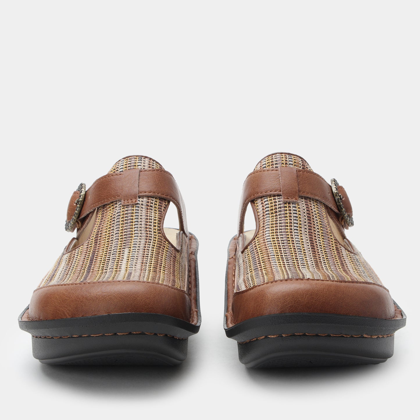 Pair of brown clogs with woven pattern on a white background
