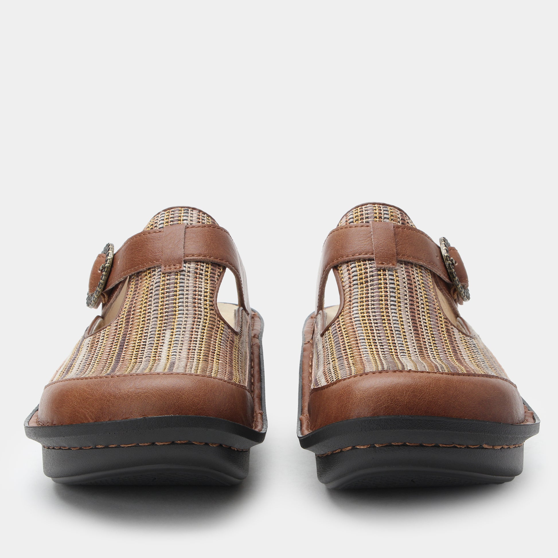 Pair of brown clogs with woven pattern on a white background