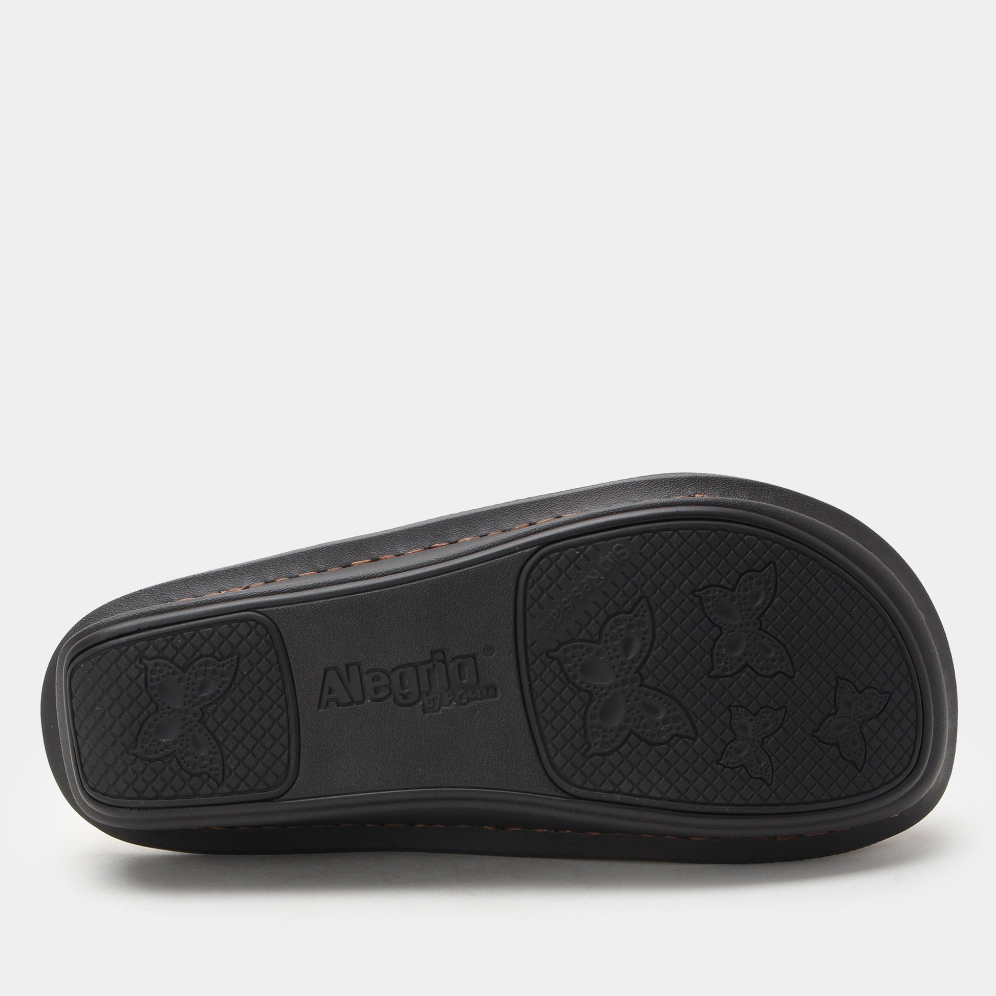 Black clogs sole with 'Alpina' branding on a light gray background