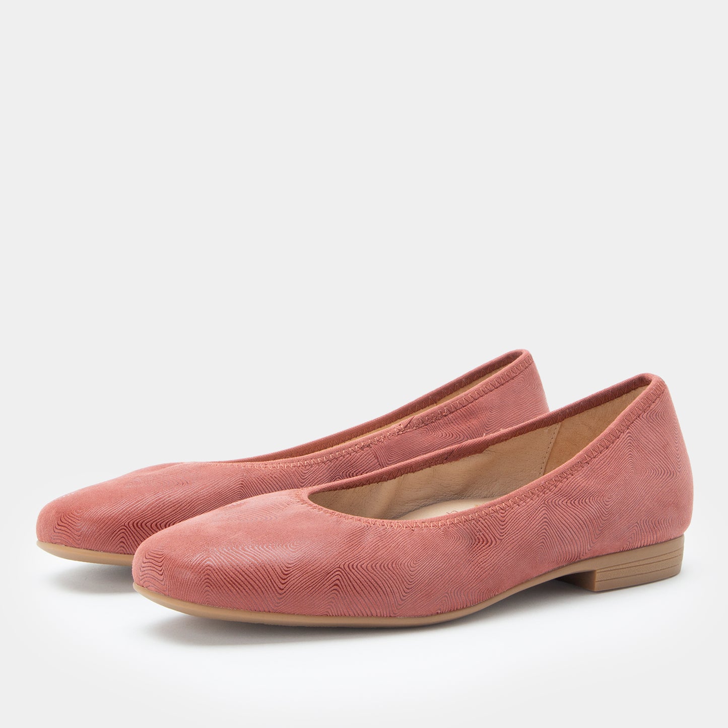 Pair of pink shoes on a white background