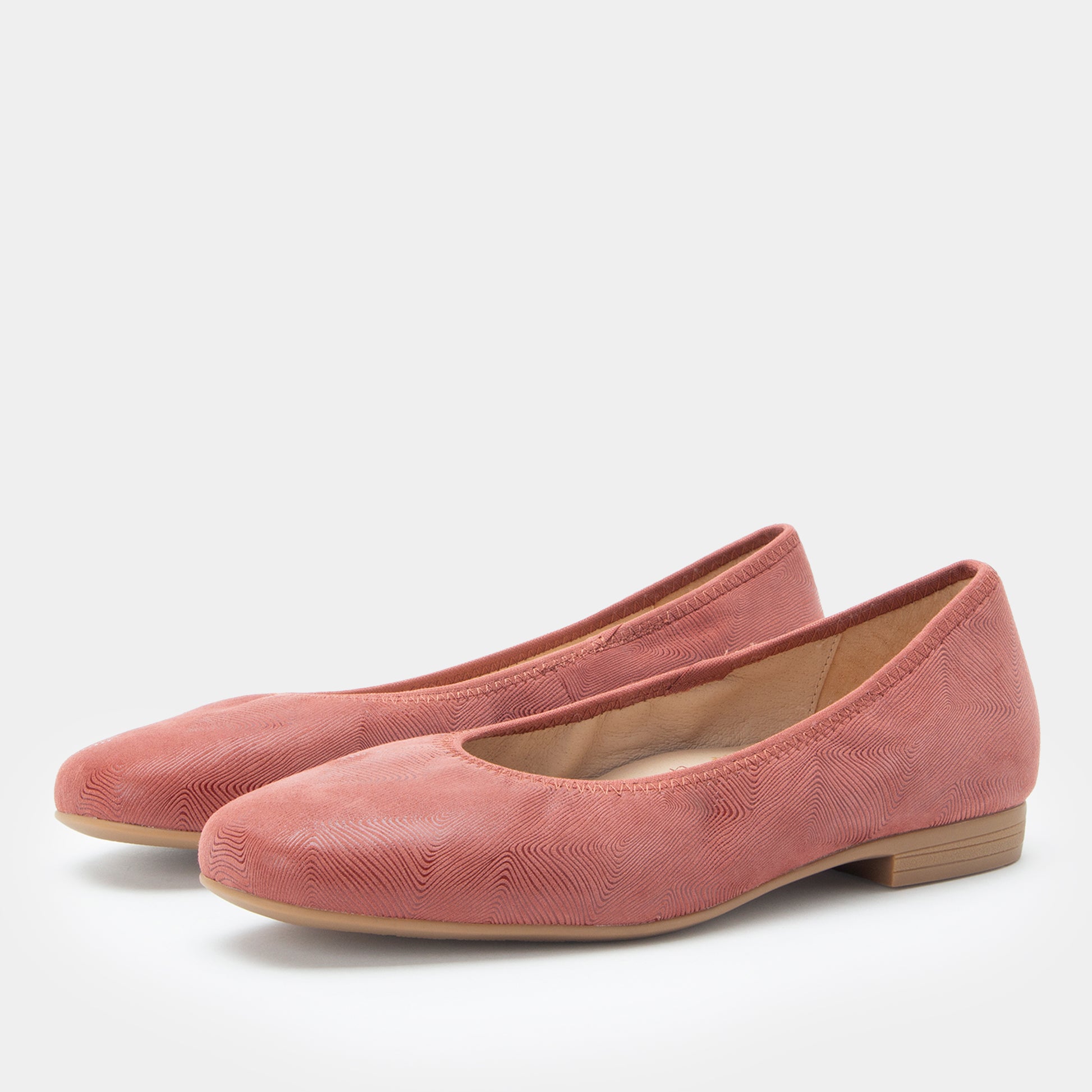 Pair of pink shoes on a white background