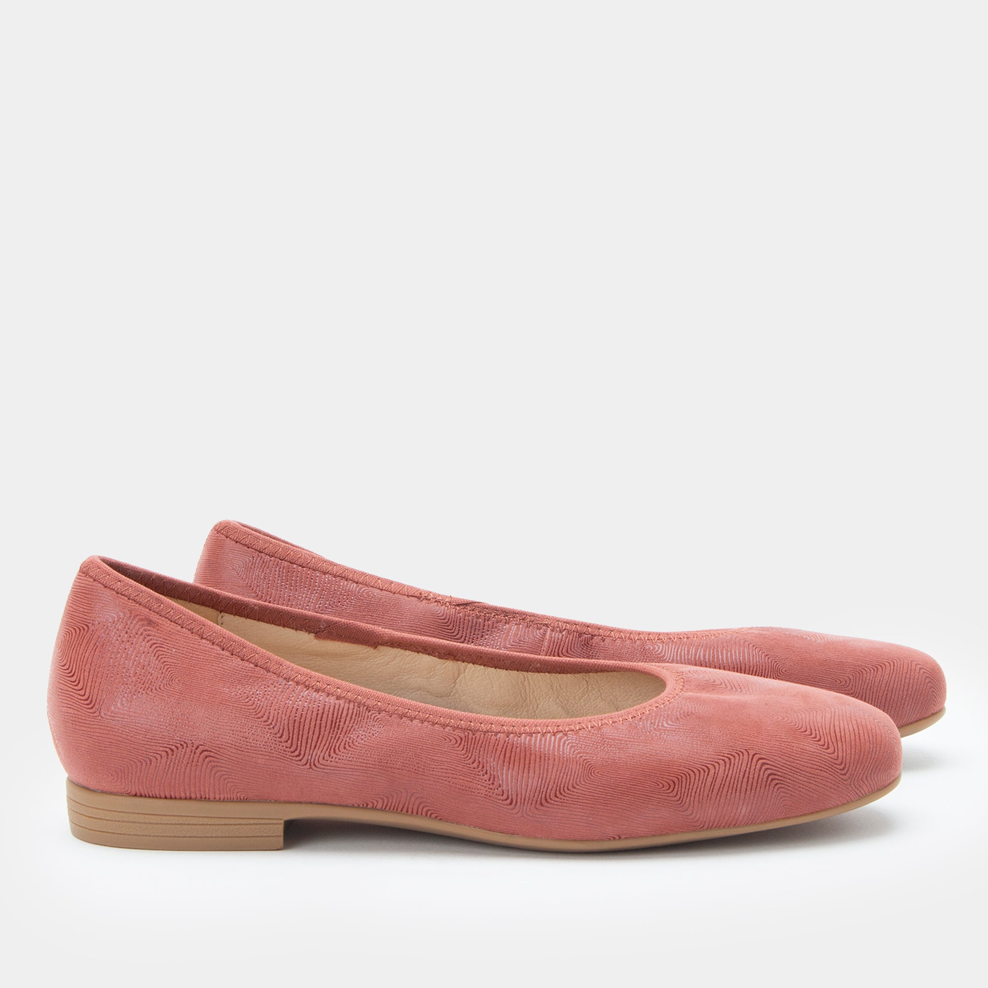 Pair of pink flats on a white background