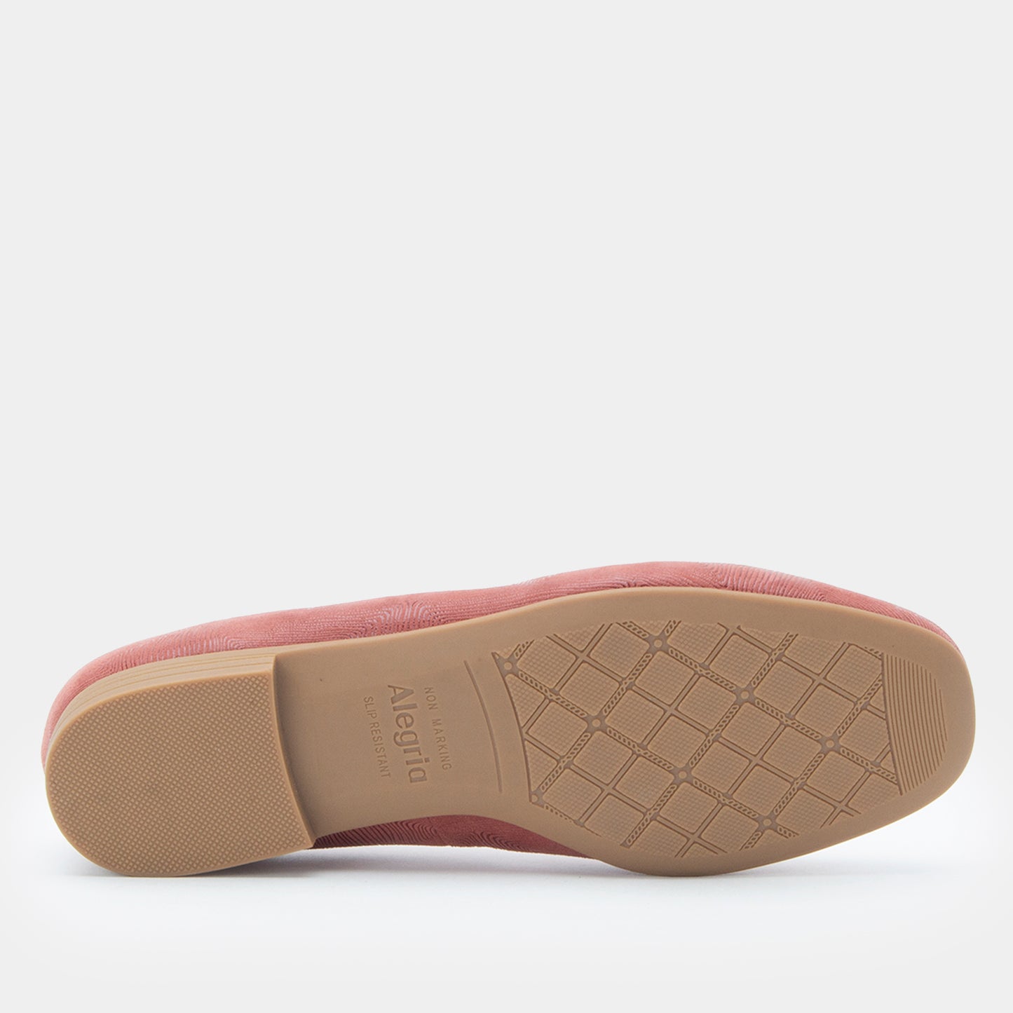 Pink slip-on shoe with a textured sole on a white background
