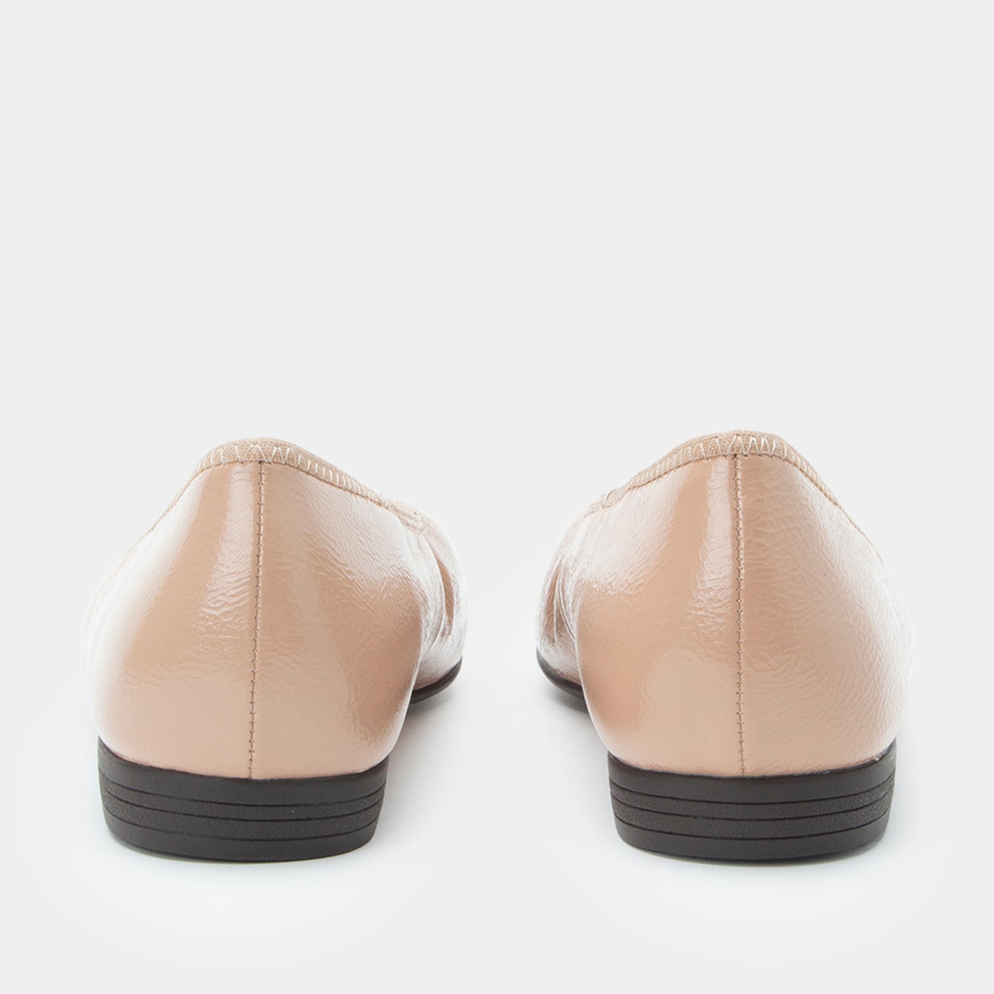 Pair of beige shoes on a white background