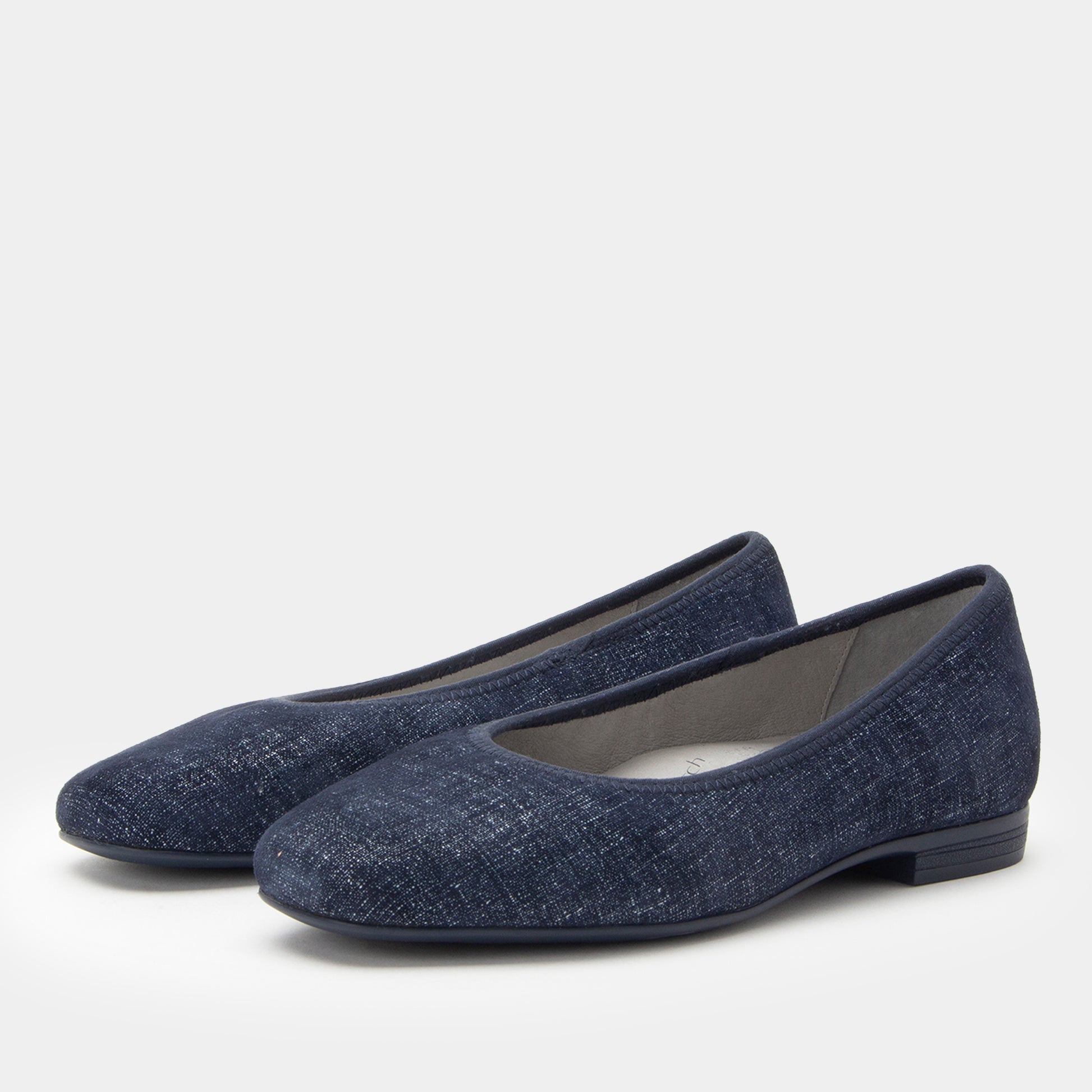 Pair of dark gray slip-on shoes on a white background