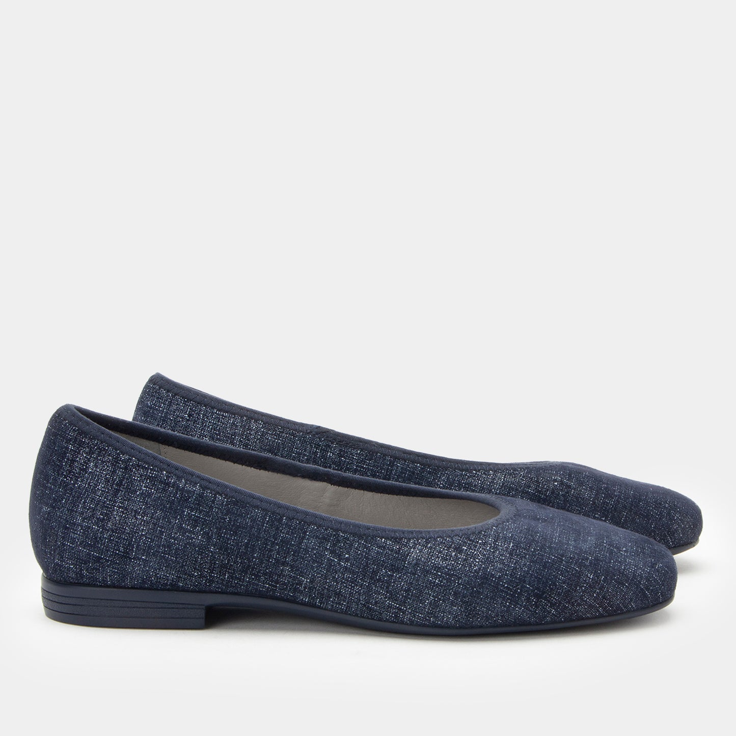 Pair of blue flat shoes on a white background