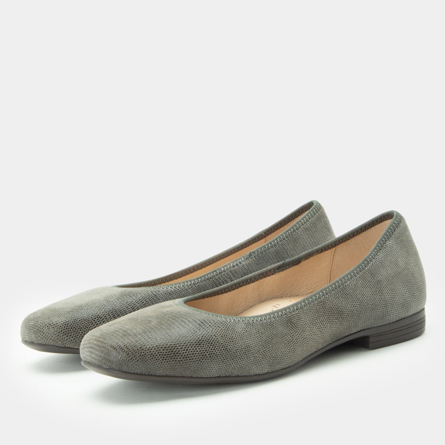 Pair of gray suede shoes on a white background